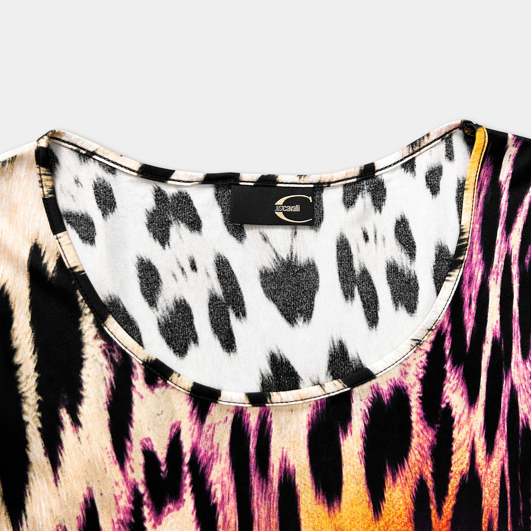 A close-up view of a colorful, patterned fabric with a black and white leopard print design.