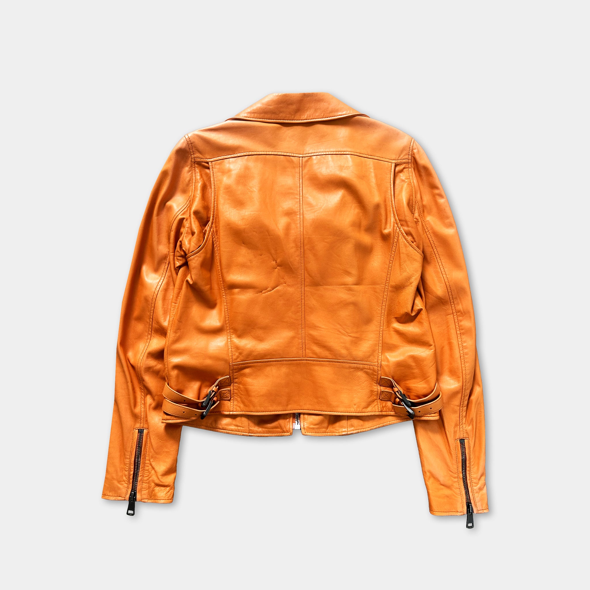 a bright orange leather jacket with long sleeves and a zipper, displayed against a plain white background.