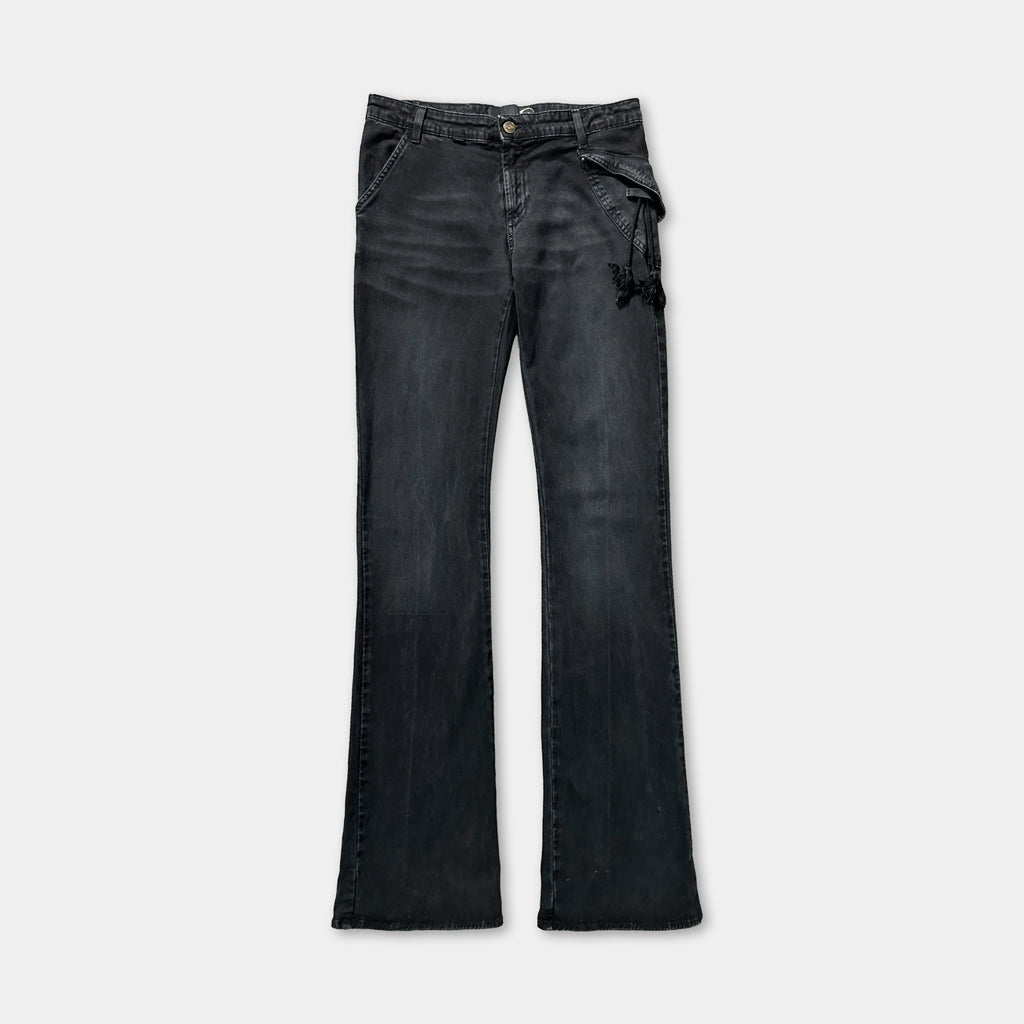 A pair of black flared jeans with a zipper detail on the side.