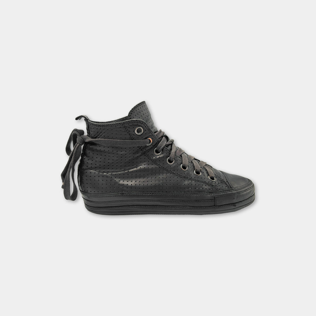 A black high-top sneaker with a perforated sole and laces.