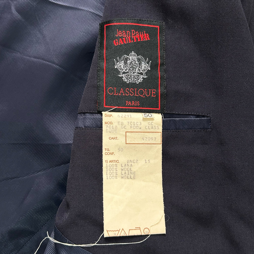 a close-up view of a jacket's label, which is attached to the jacket's pocket. The label appears to be a tag or receipt, and it is attached to the jacket with a string.
