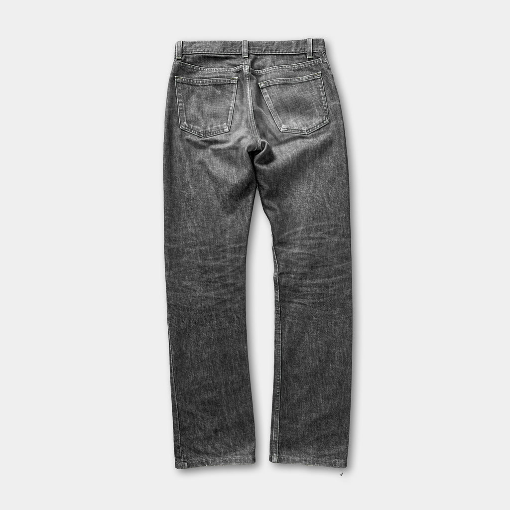 A pair of well-worn, dark gray jeans with visible signs of use and wear.