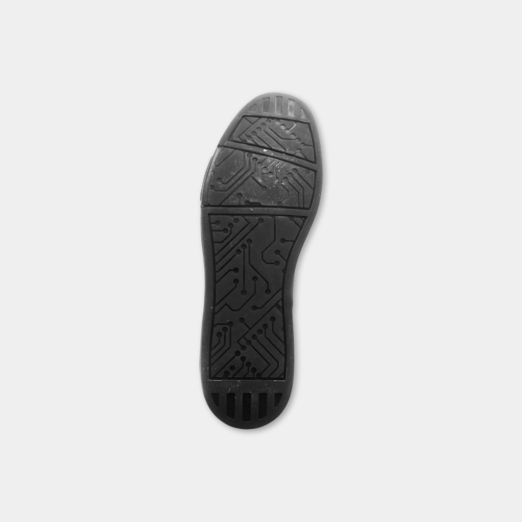 A black shoe sole with a circuit pattern on it.