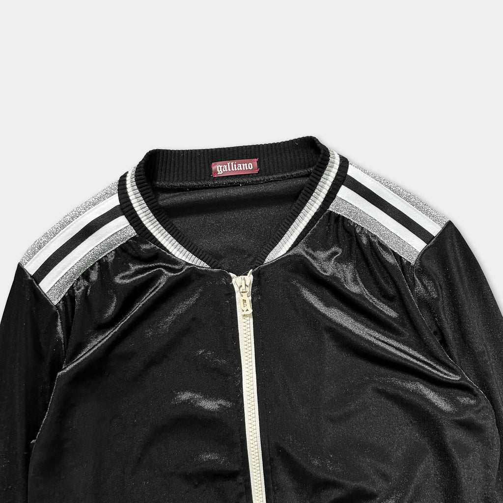 A black zip-up jacket with white stripes on the sleeves and collar.