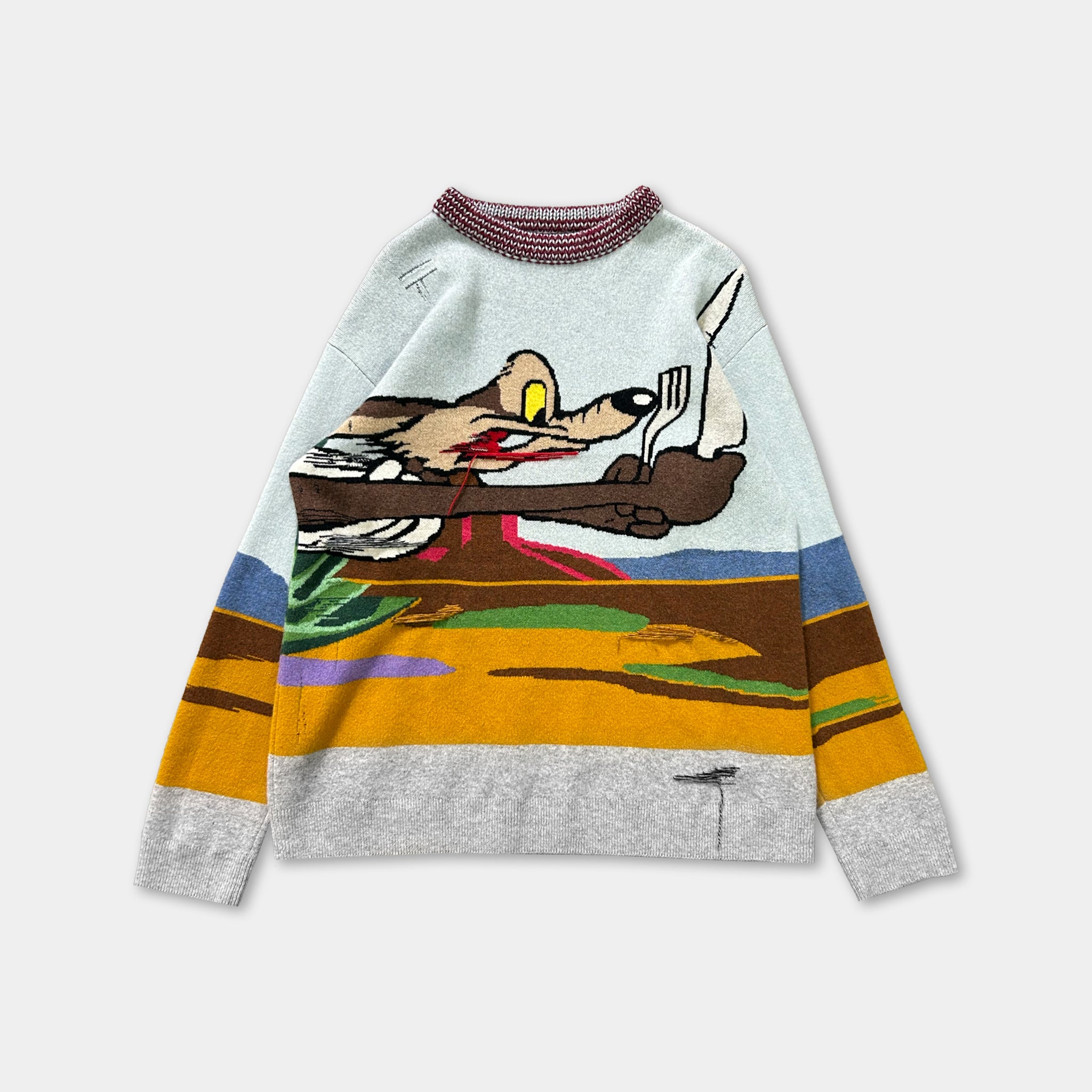 A colorful, cartoon-style sweater with a wolf character on it.