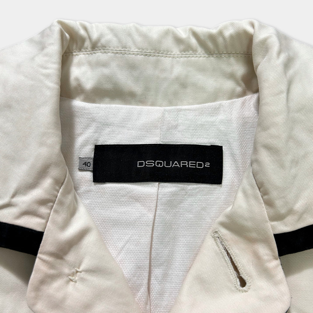 a close-up view of a white jacket with a black collar and a black label on the back, displaying the brand name "DSQUARED".