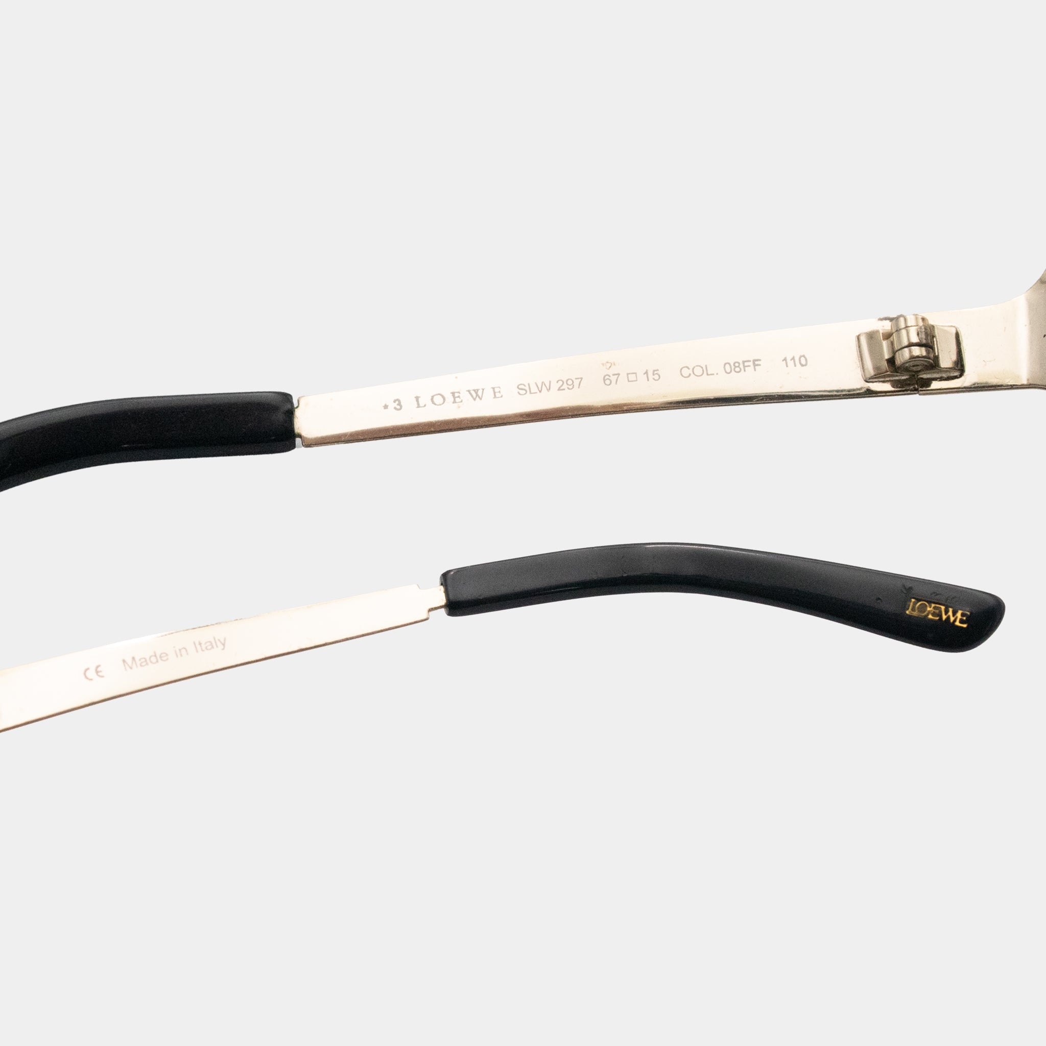 A close-up view of a pair of sunglasses with a black frame and a silver frame, featuring the Lotte brand name and model information.