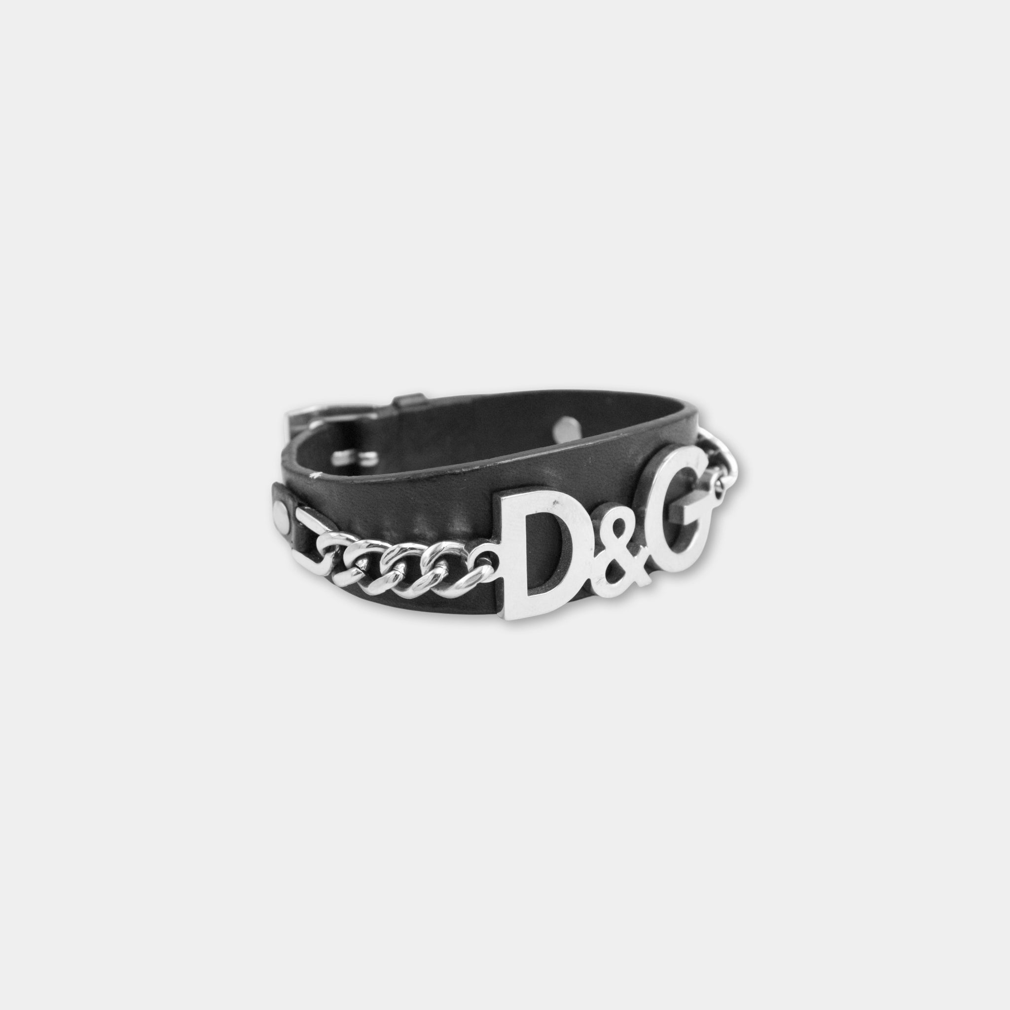 A black leather bracelet with silver lettering on it.