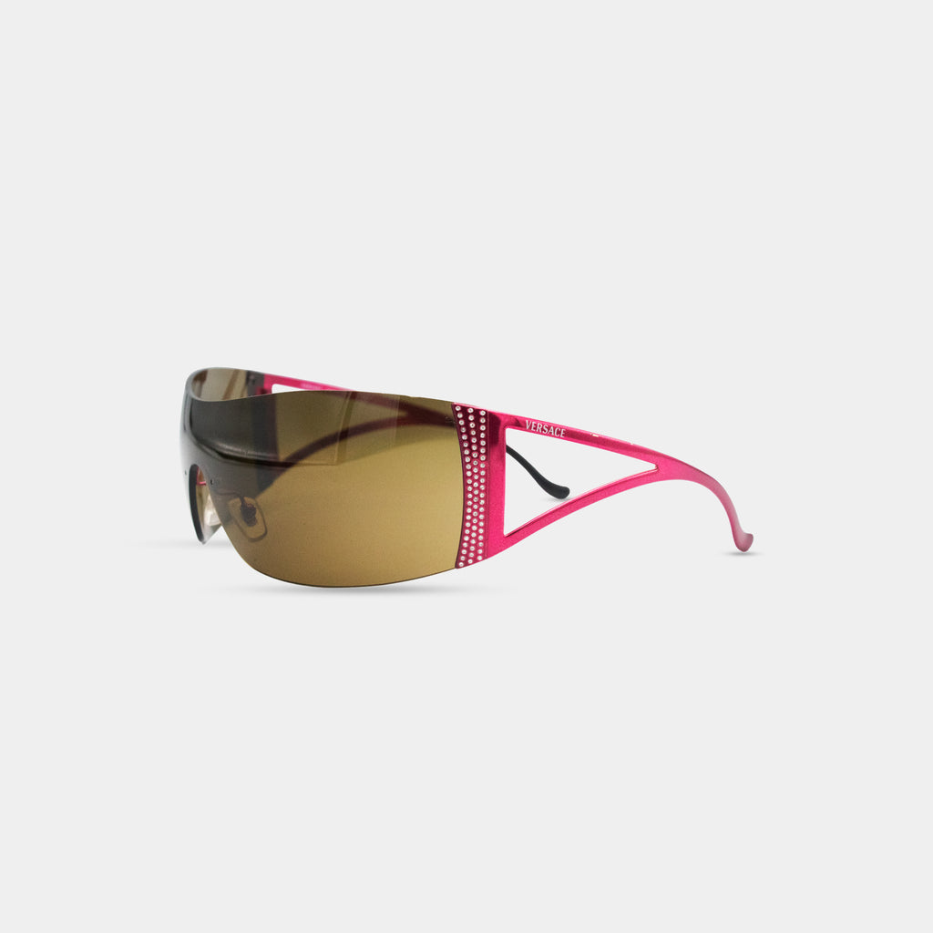 A pair of pink sunglasses with a brown frame and rhinestones on the side.