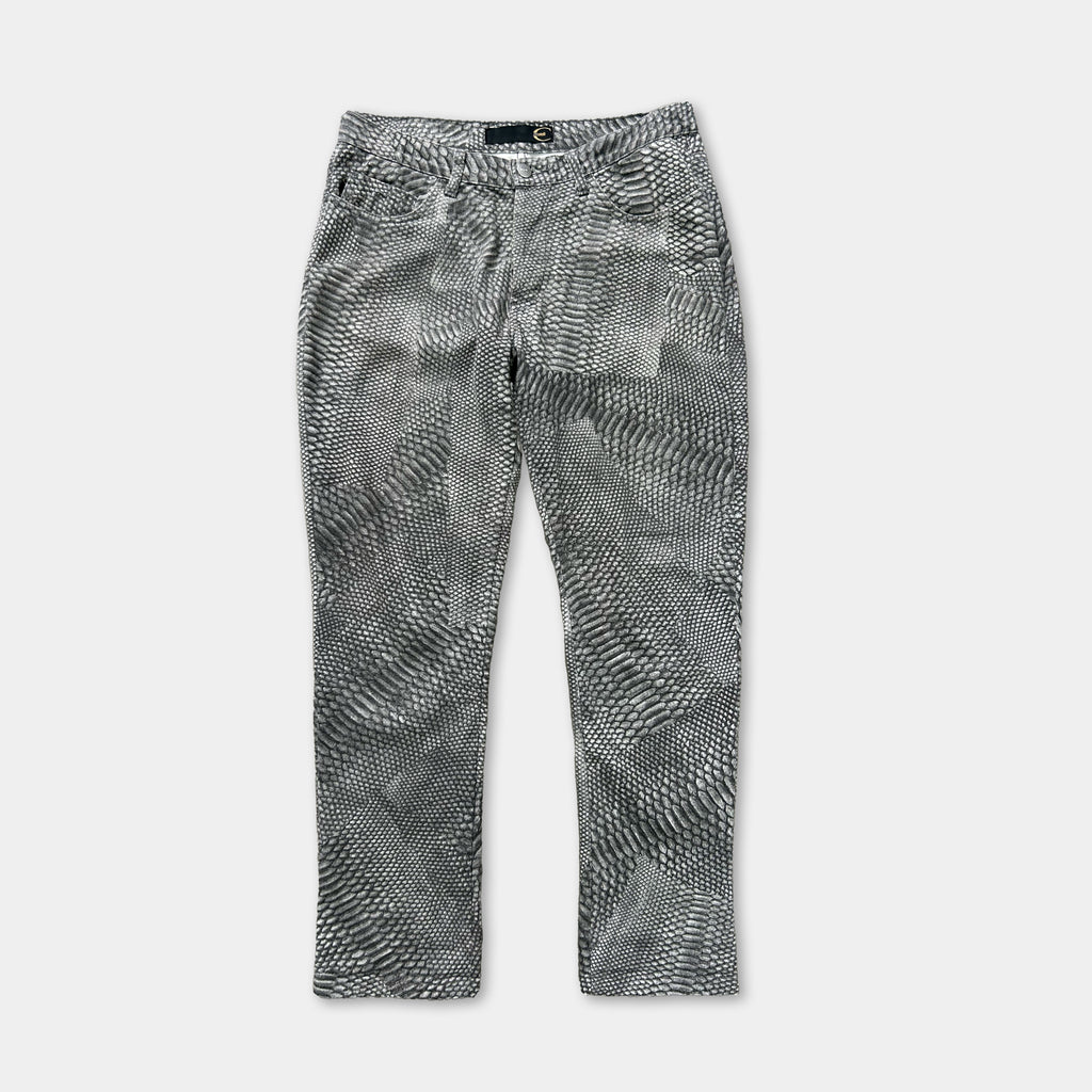 A pair of black and white patterned jeans with a distinctive snake skin-like design.