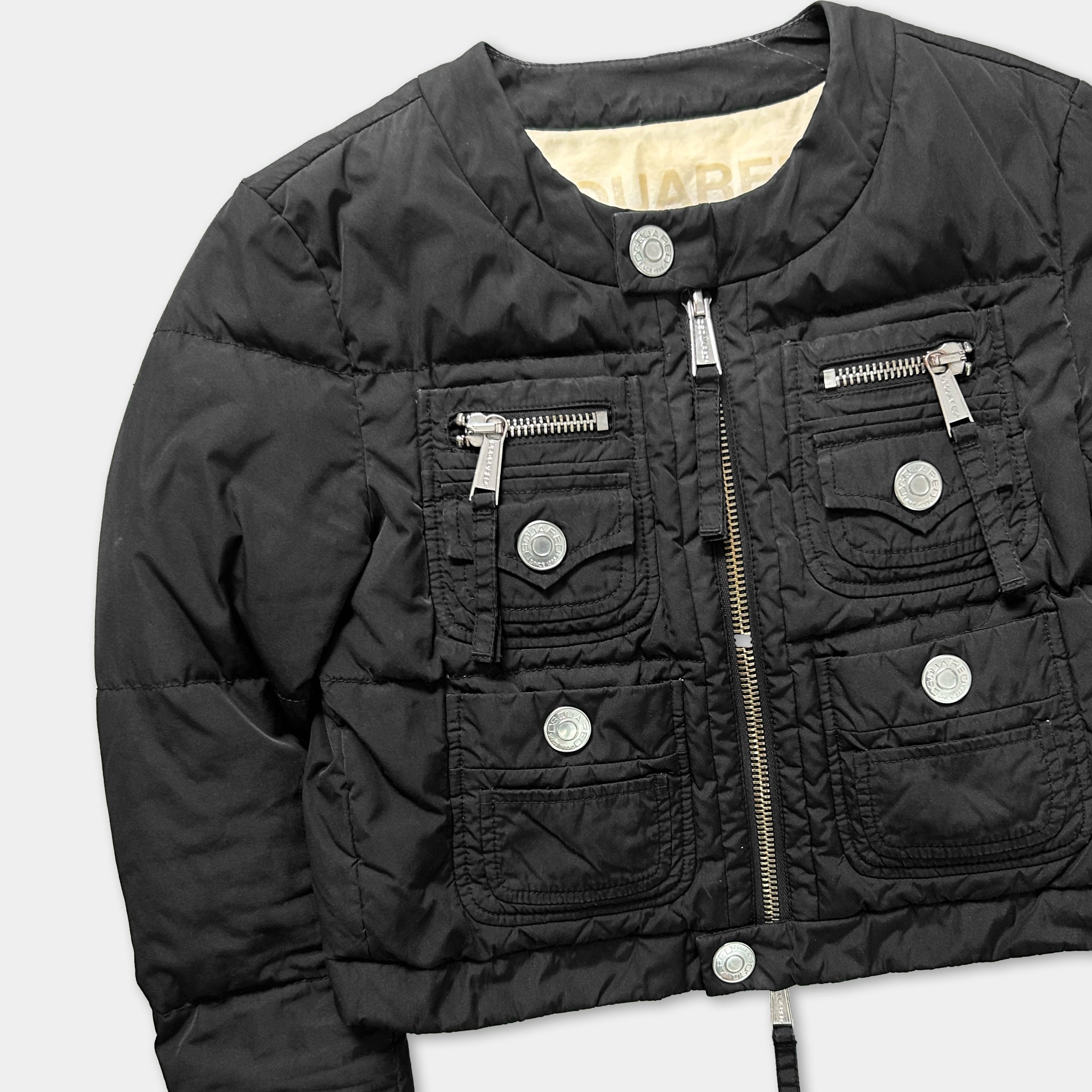 A black puffer jacket with multiple pockets and zippers.