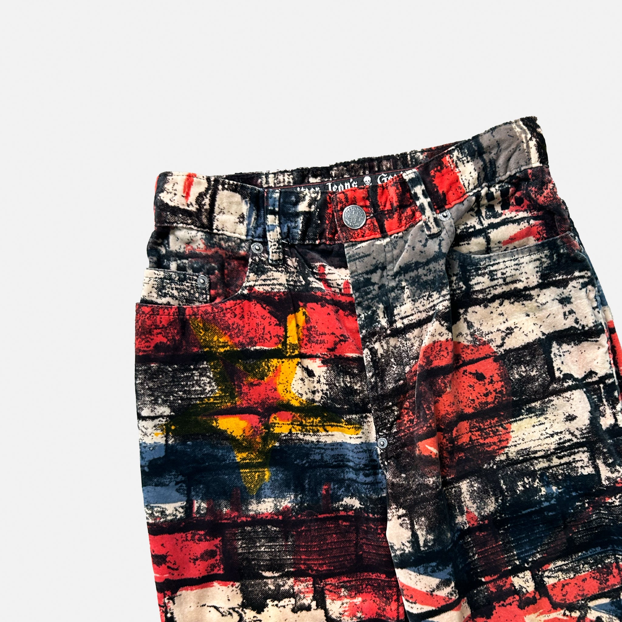 A pair of colorful, patterned jeans with a bold, abstract design.