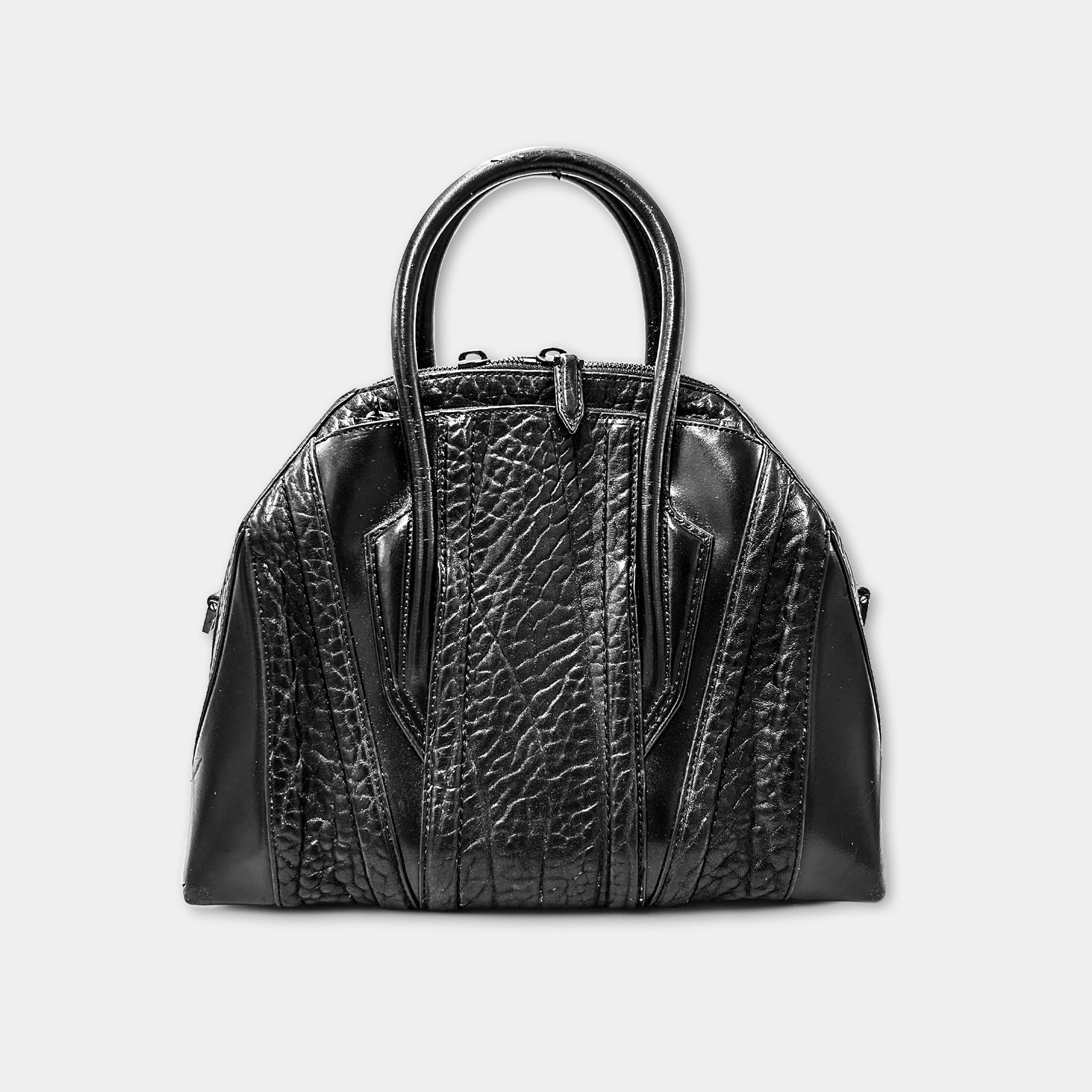 A black leather handbag with a textured pattern and two handles.