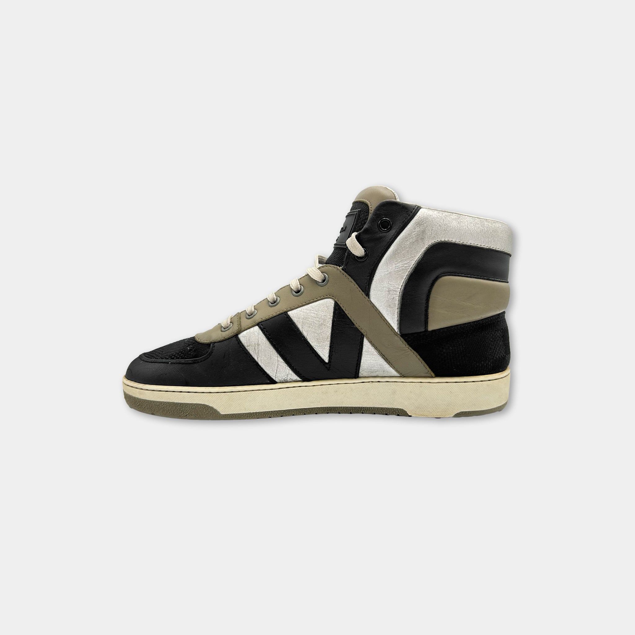 A black and white sneaker with a white sole and a black upper.