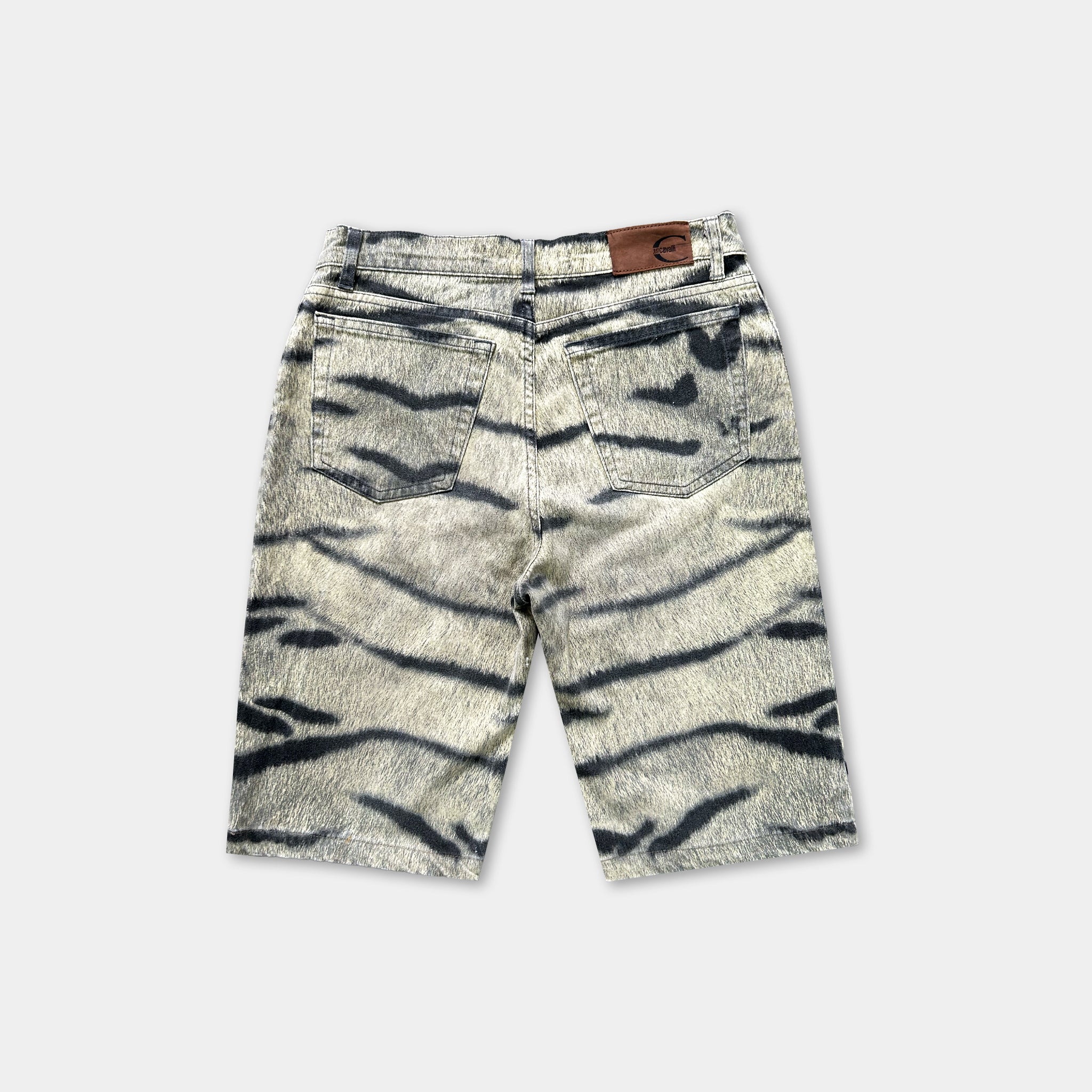 A pair of gray and black striped jeans with a brown leather patch on the back pocket.