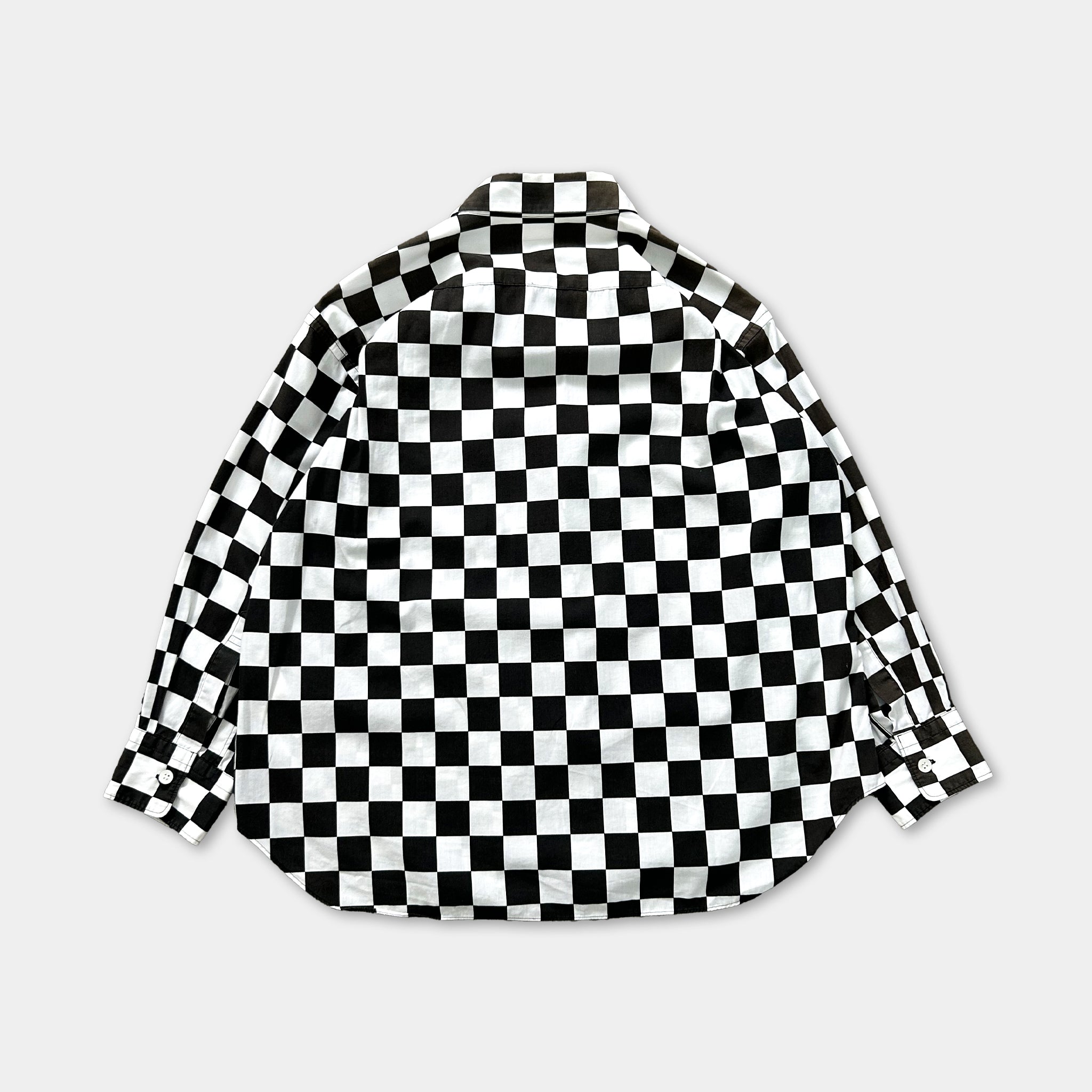 a black and white checkered shirt laid out flat against a white background.