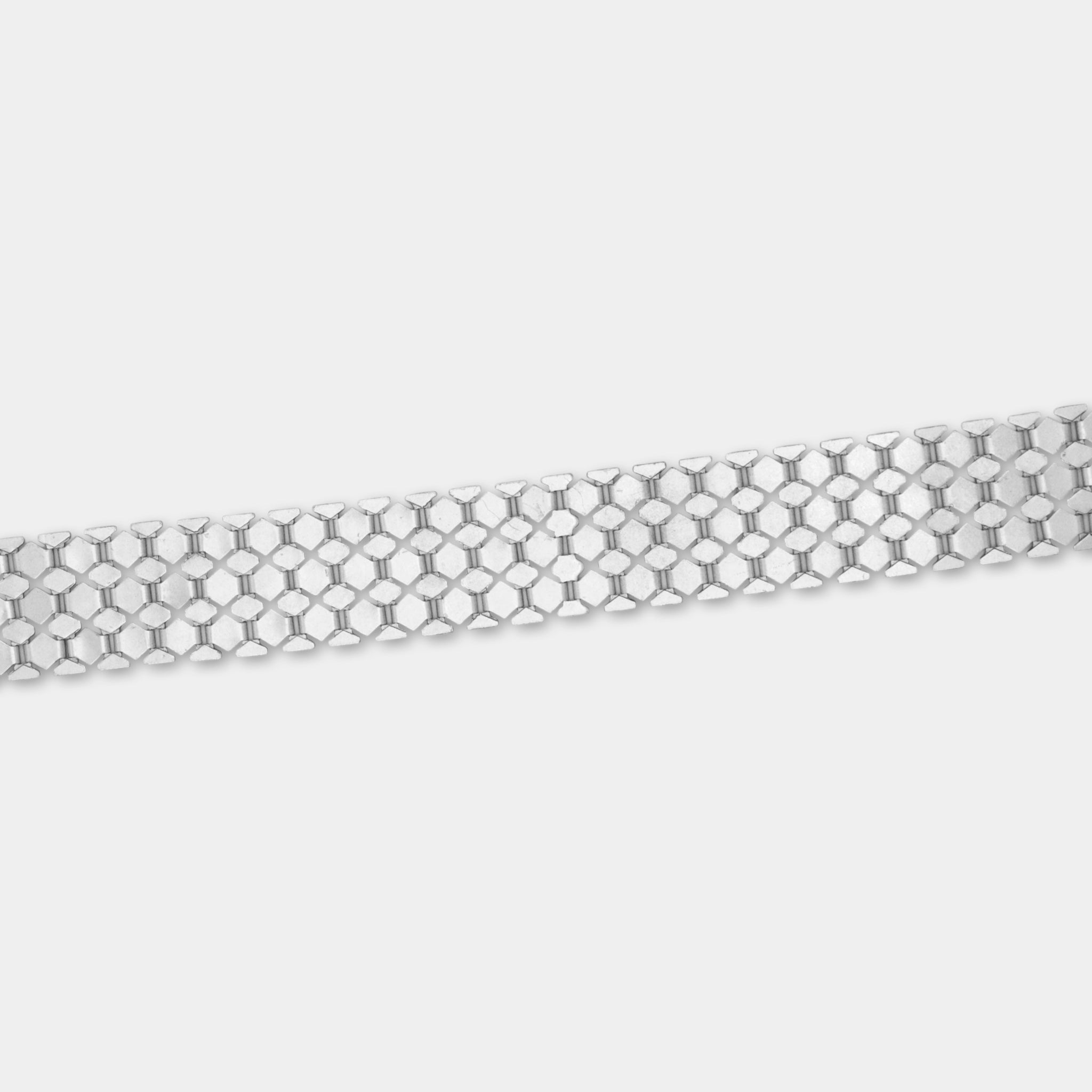 A silver-colored metal bracelet with a repeating pattern of small hexagonal shapes.