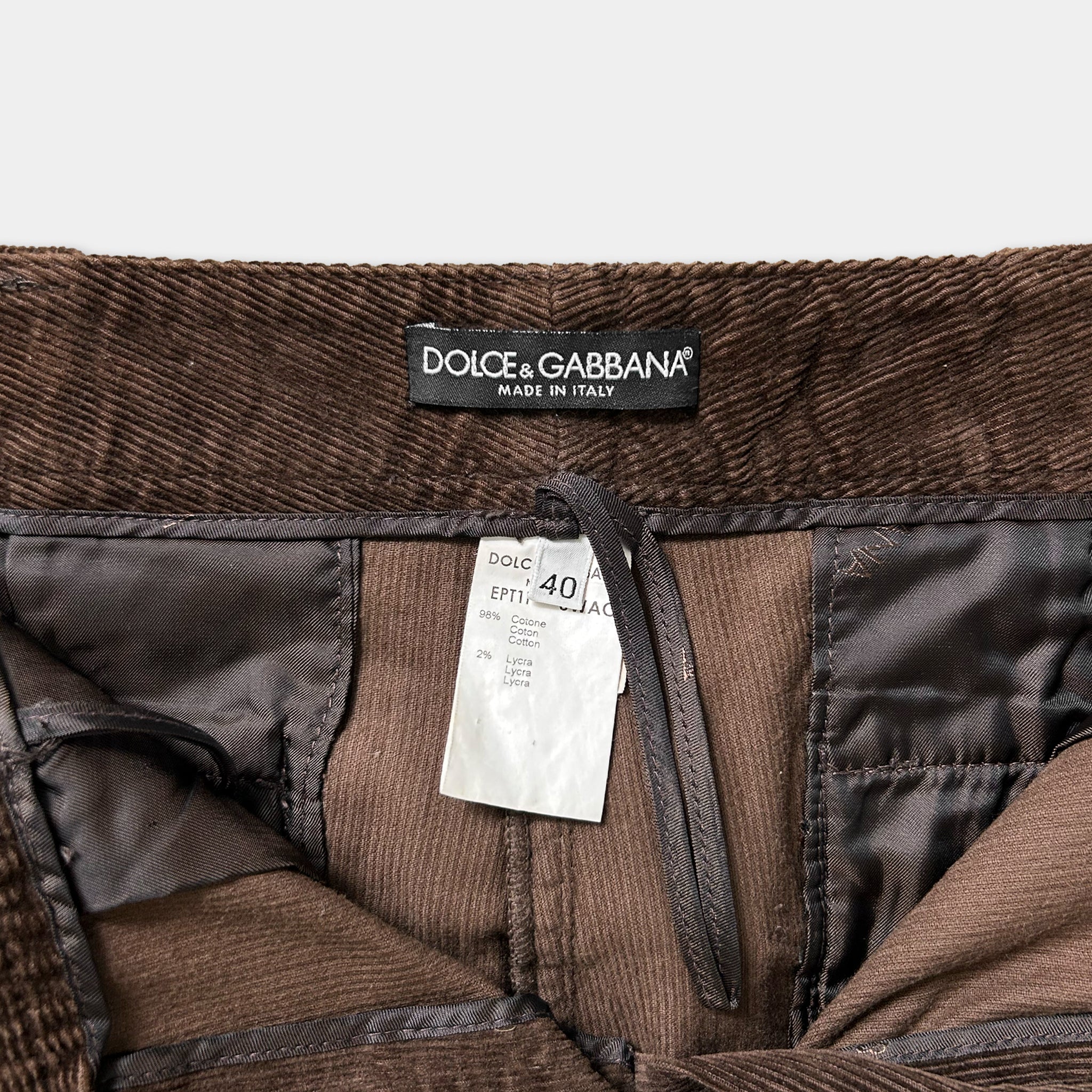 a close-up view of a brown corduroy waistcoat with a label attached to it.
