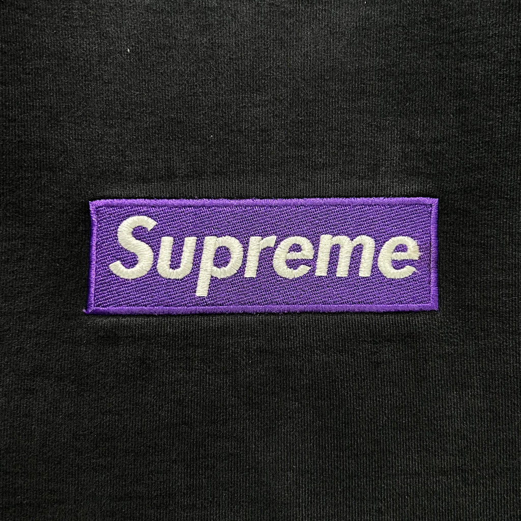 A purple box logo with the word "Superme" printed on a black background.