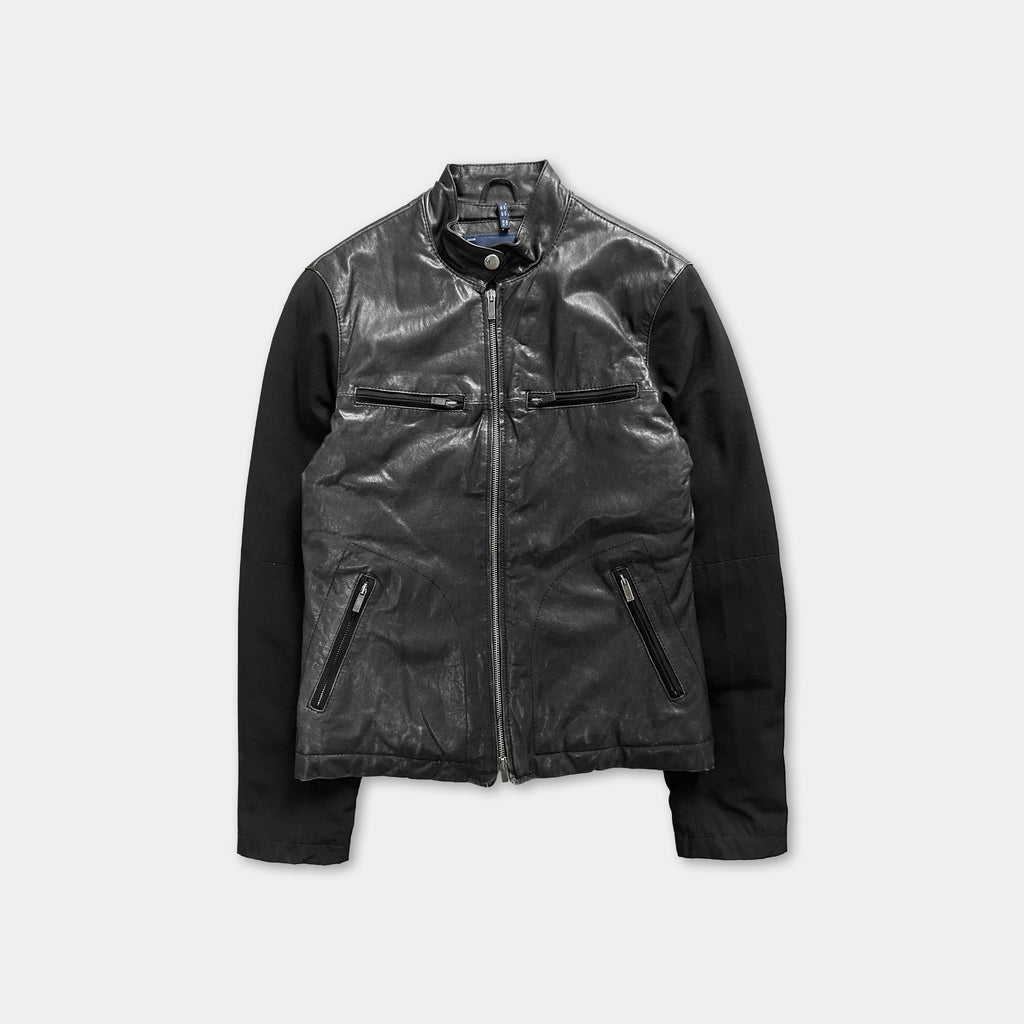 A black leather jacket with a zipper and two pockets, displayed against a white background.