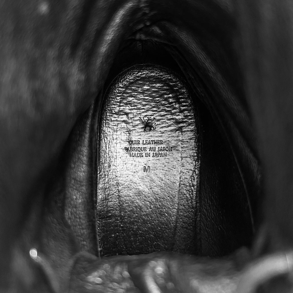 the interior of a leather boot, specifically the sole and the interior of the shoe.