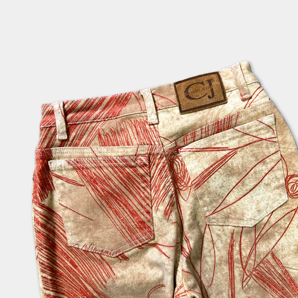 a pair of beige jeans with a red and white patterned design.
