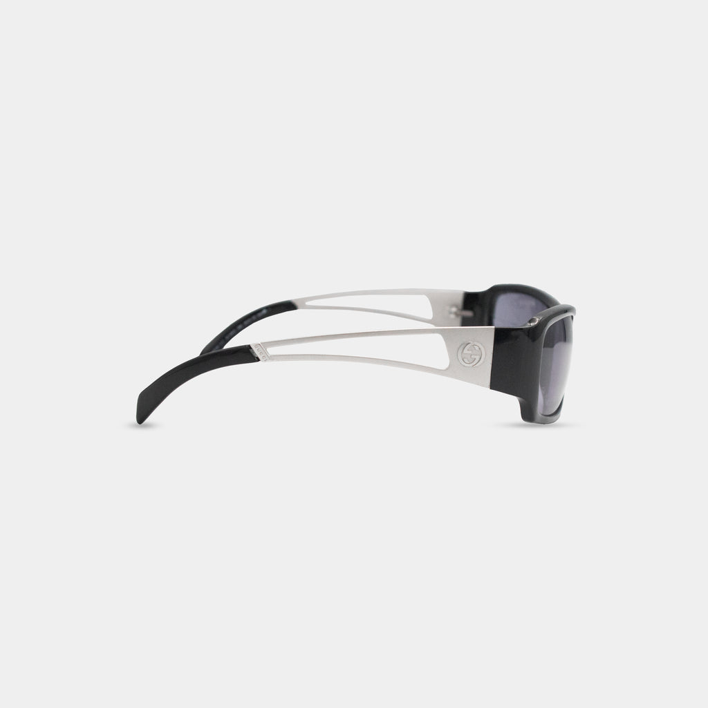 A pair of black and silver sunglasses with a distinctive Gucci logo on the frame.