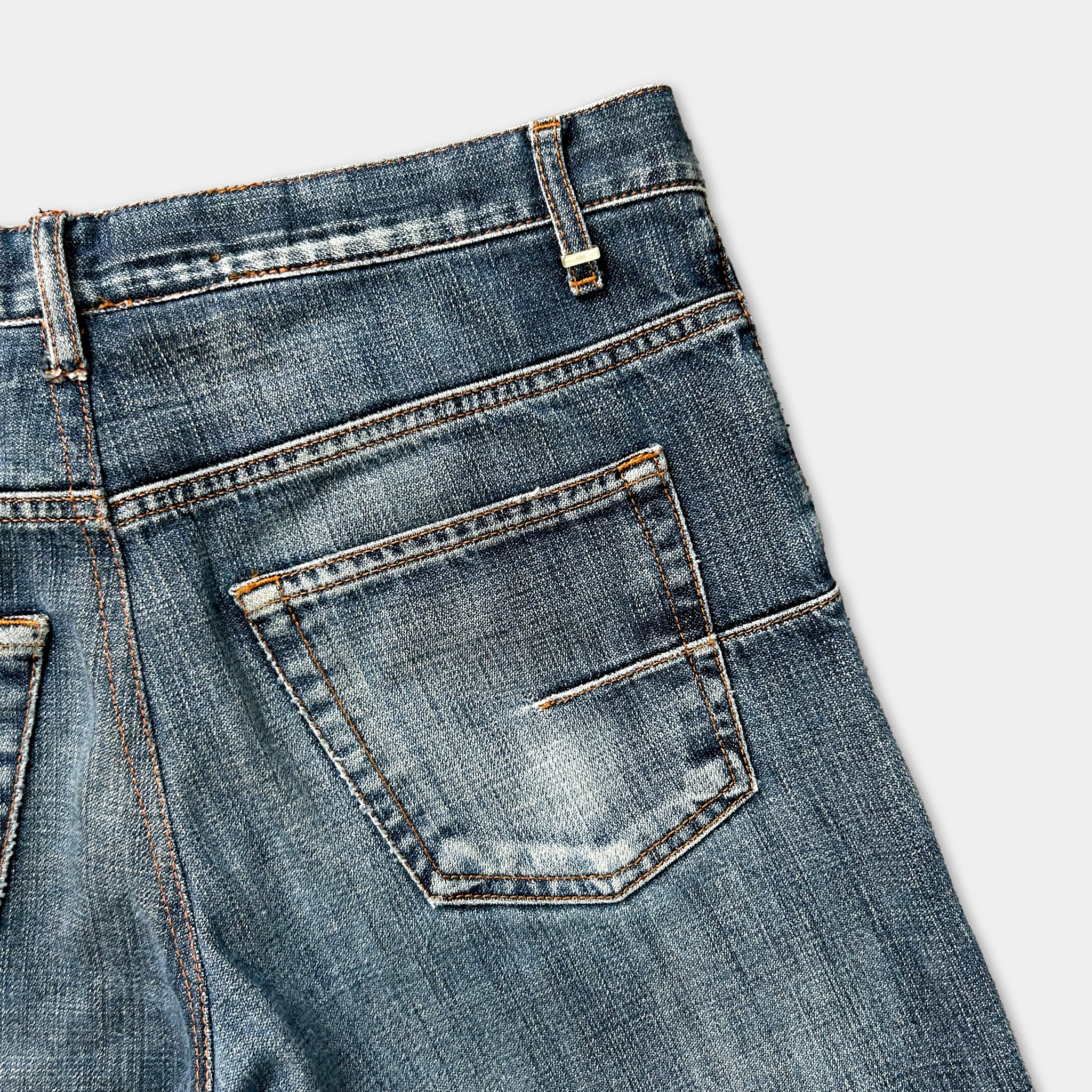 A close-up view of a pair of blue jeans, focusing on the pocket area.