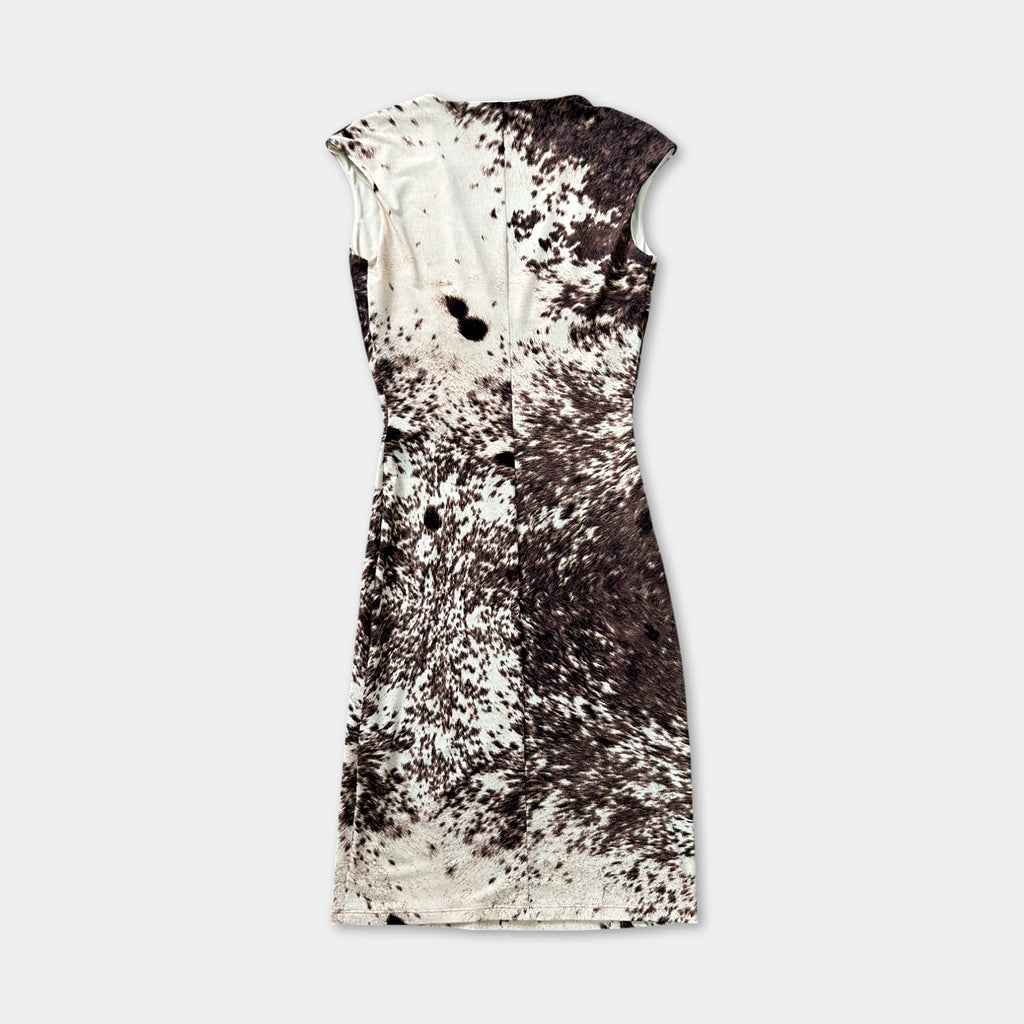 A dress with a black and white speckled pattern, featuring a sleeveless design.
