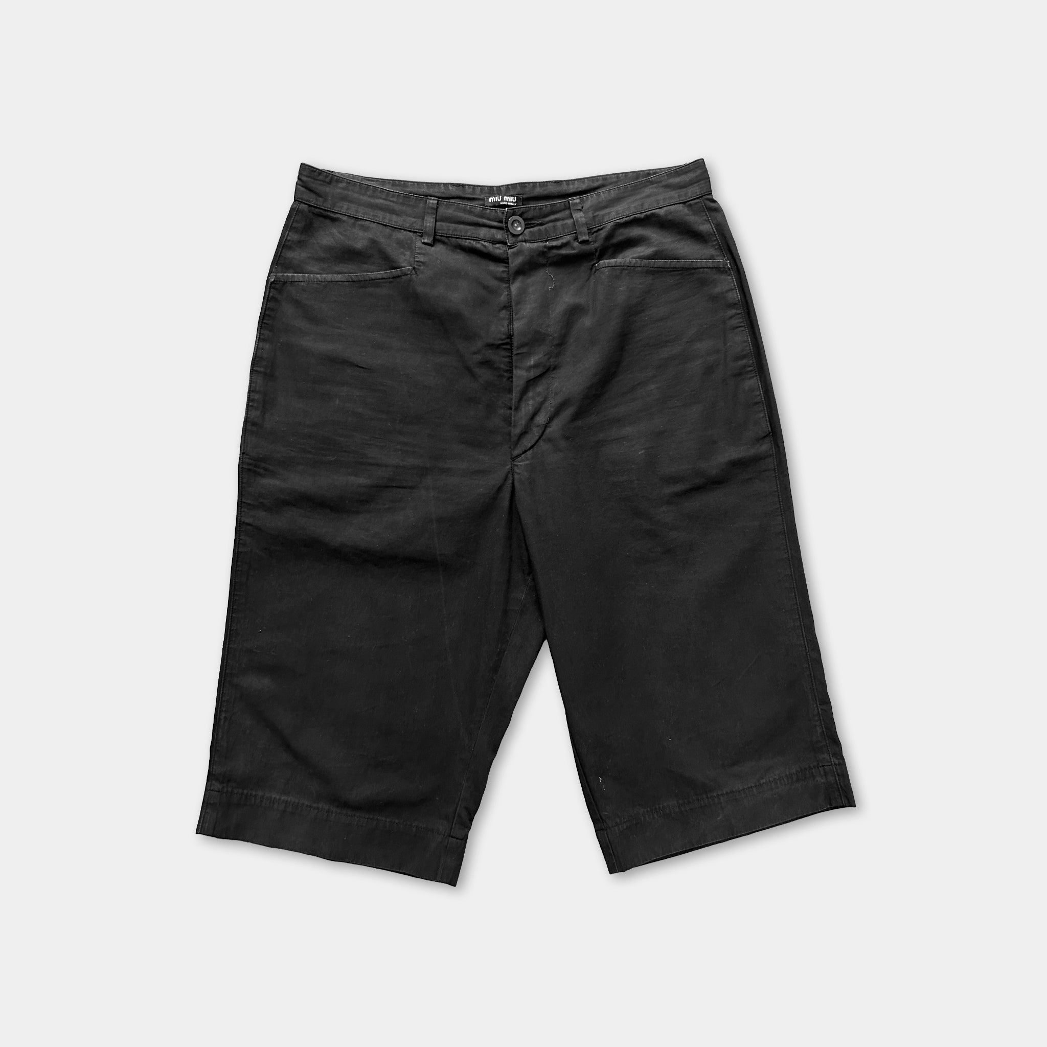 A pair of black shorts against a white background.