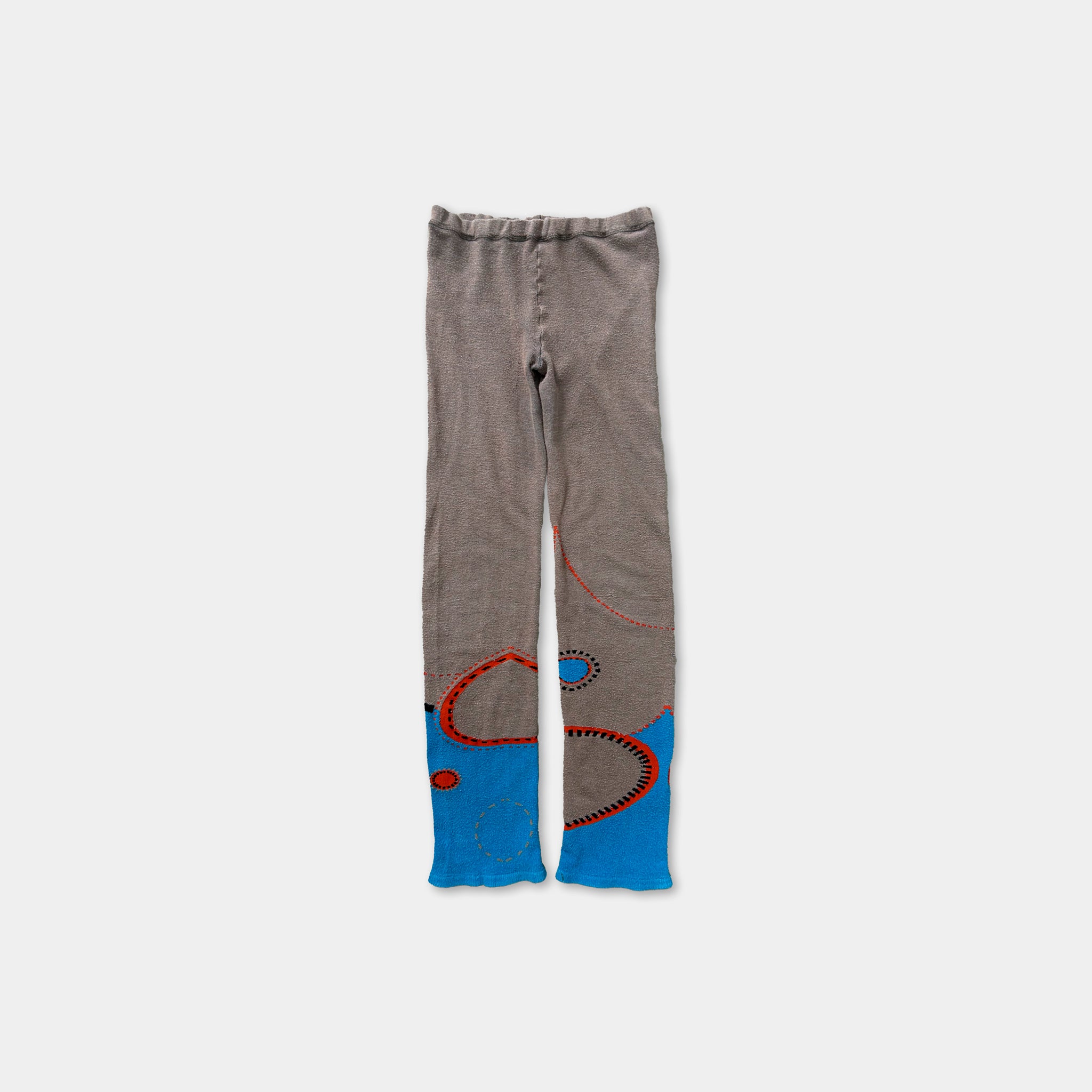 A pair of gray leggings with blue and red abstract designs on the sides.