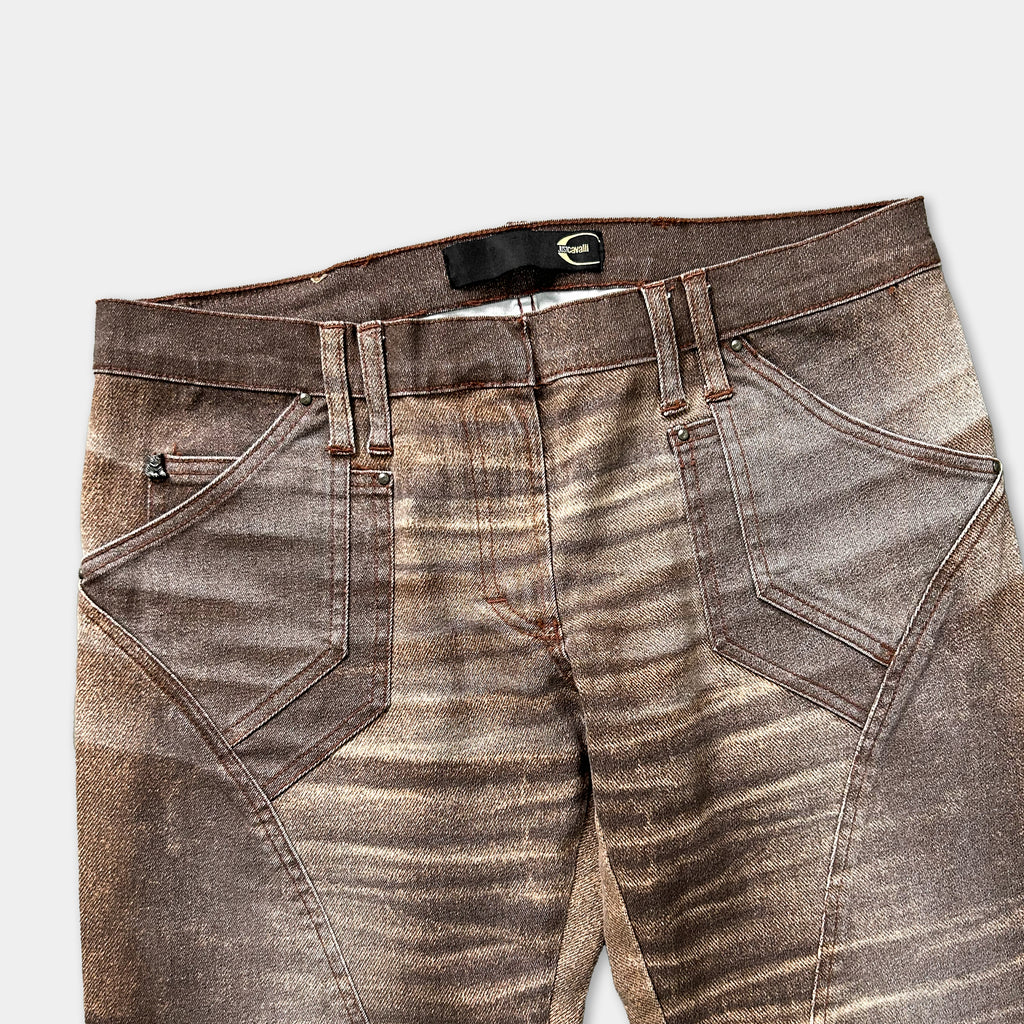 A pair of brown and tan patterned jeans with a zipper pocket and a belt loop.
