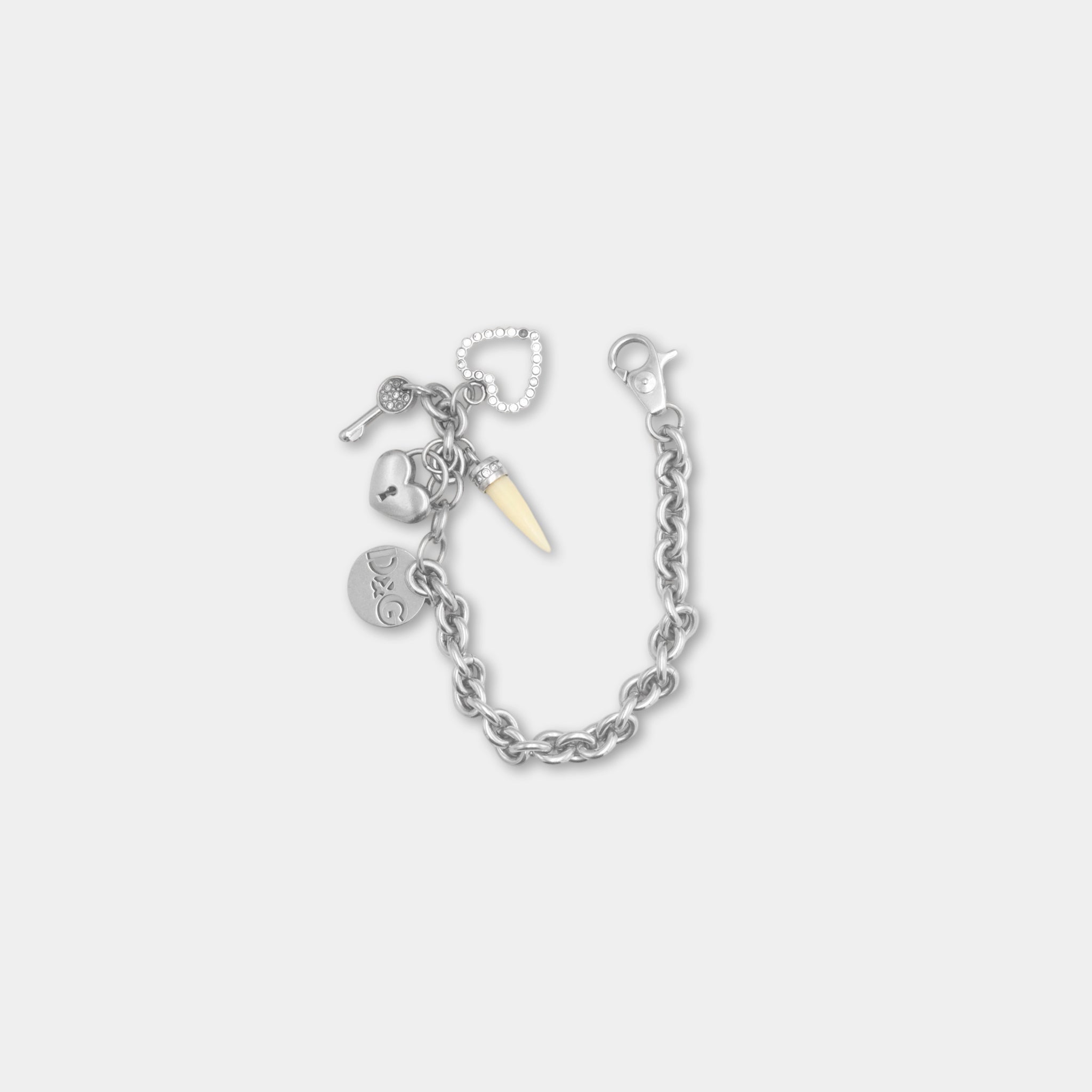 A silver-colored bracelet with various charms and a key attached to it.