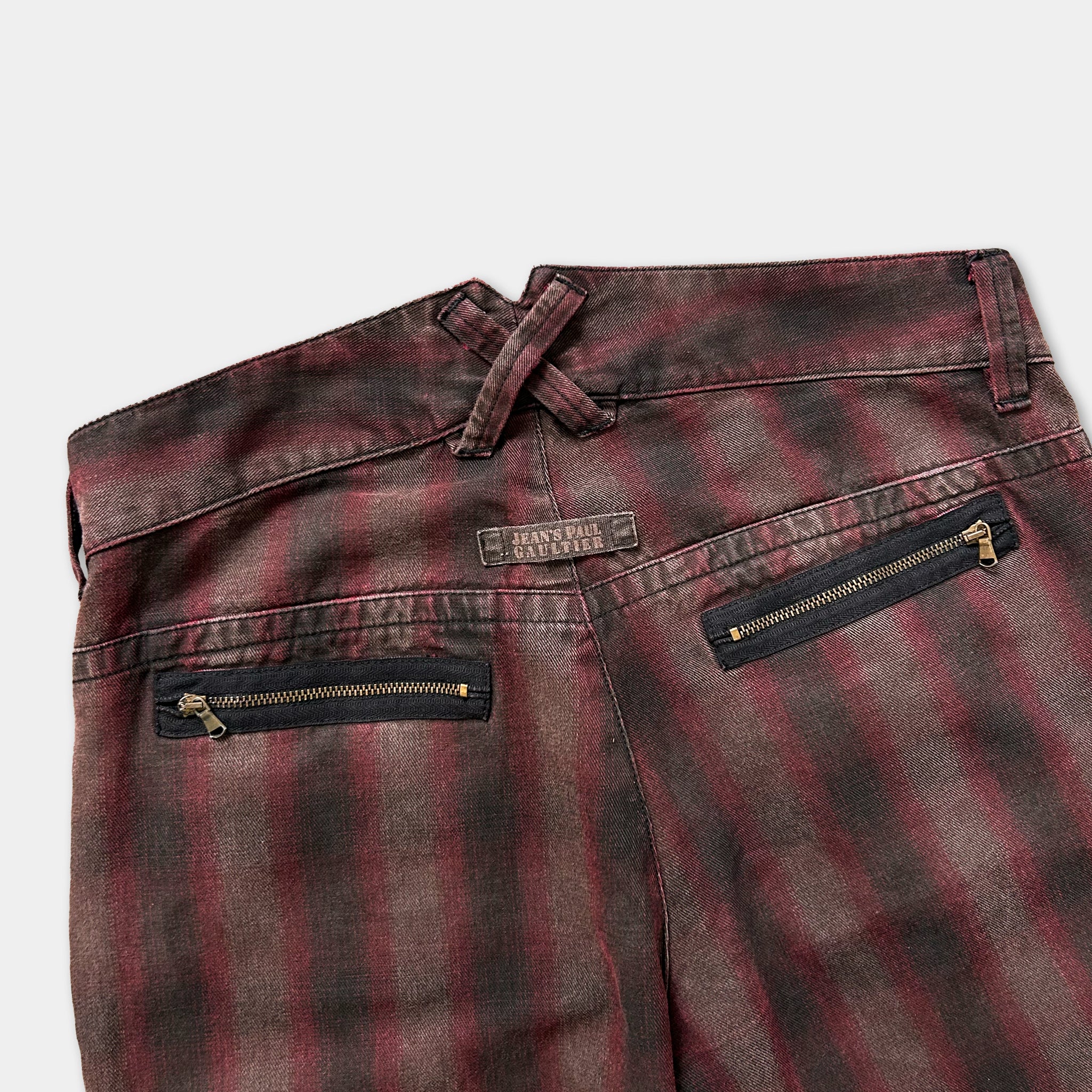 a pair of plaid jeans with a zipper pocket and a label on the waistband.