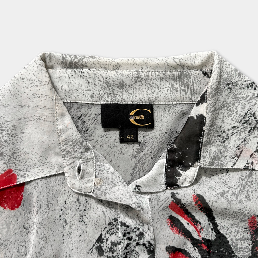a close-up view of a white and black patterned shirt collar, with a label indicating the brand and size.