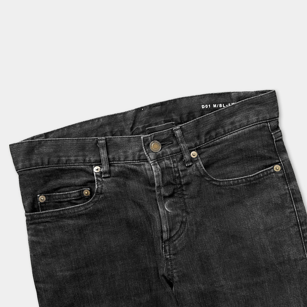 A pair of black jeans with a zipper and button closure.