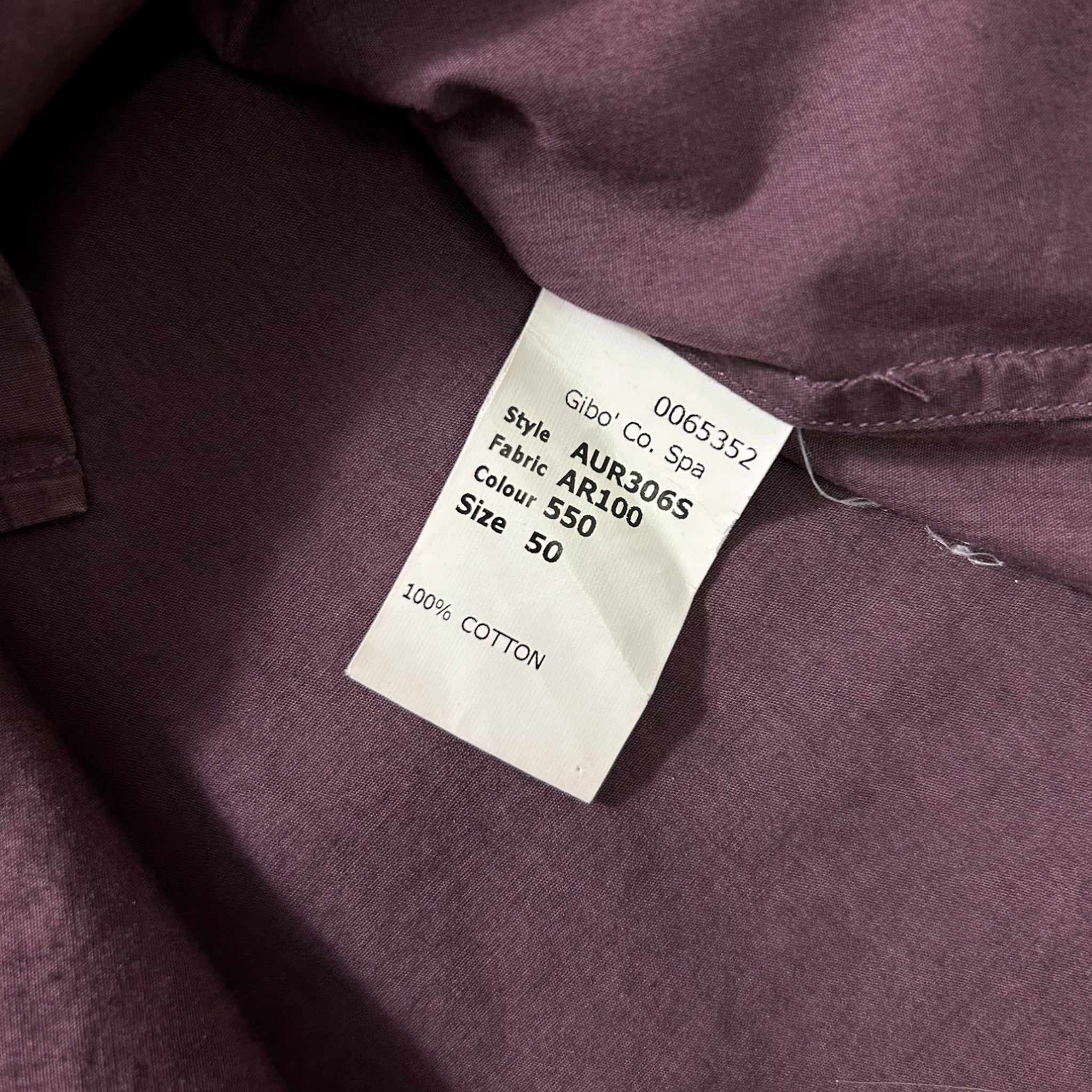 a close-up view of a fabric label attached to a piece of clothing, likely a garment or textile.