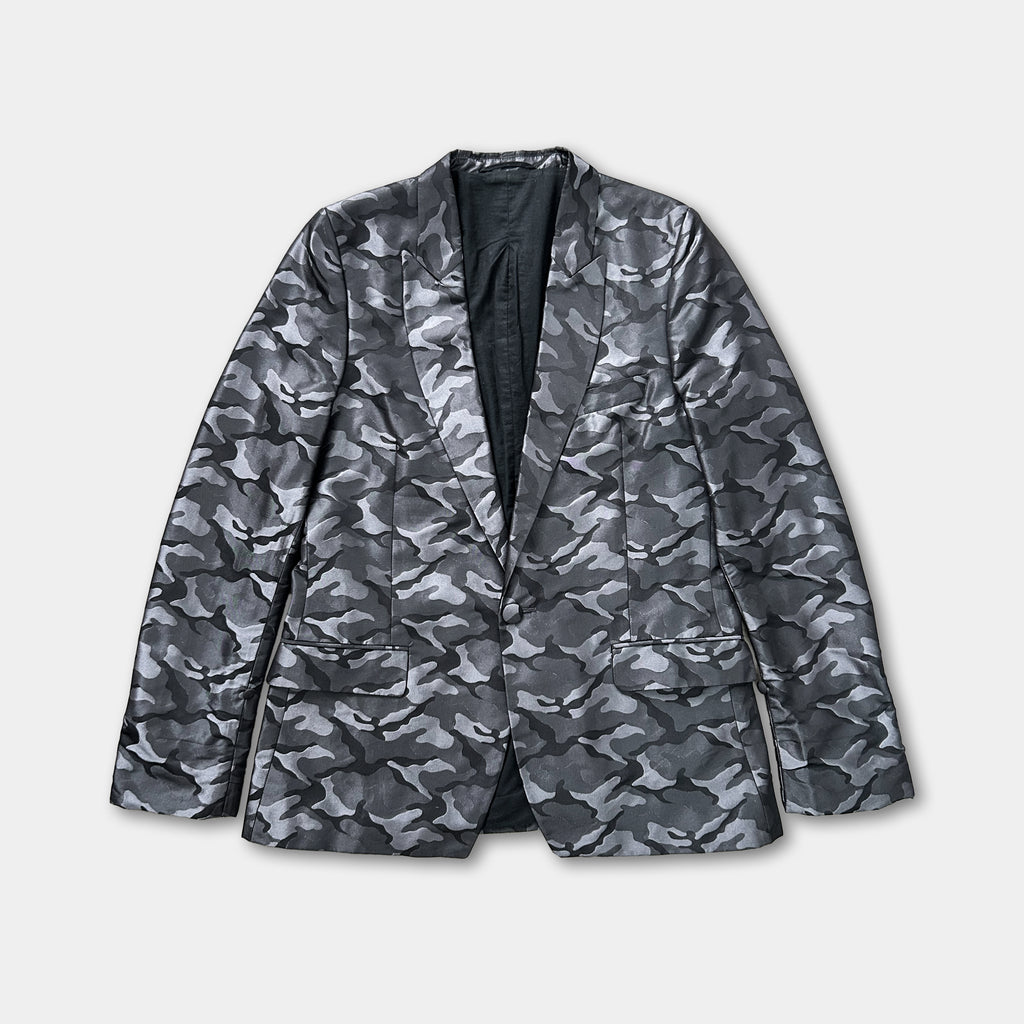 A black and grey camouflage jacket with a collar and lapels, displayed against a white background.