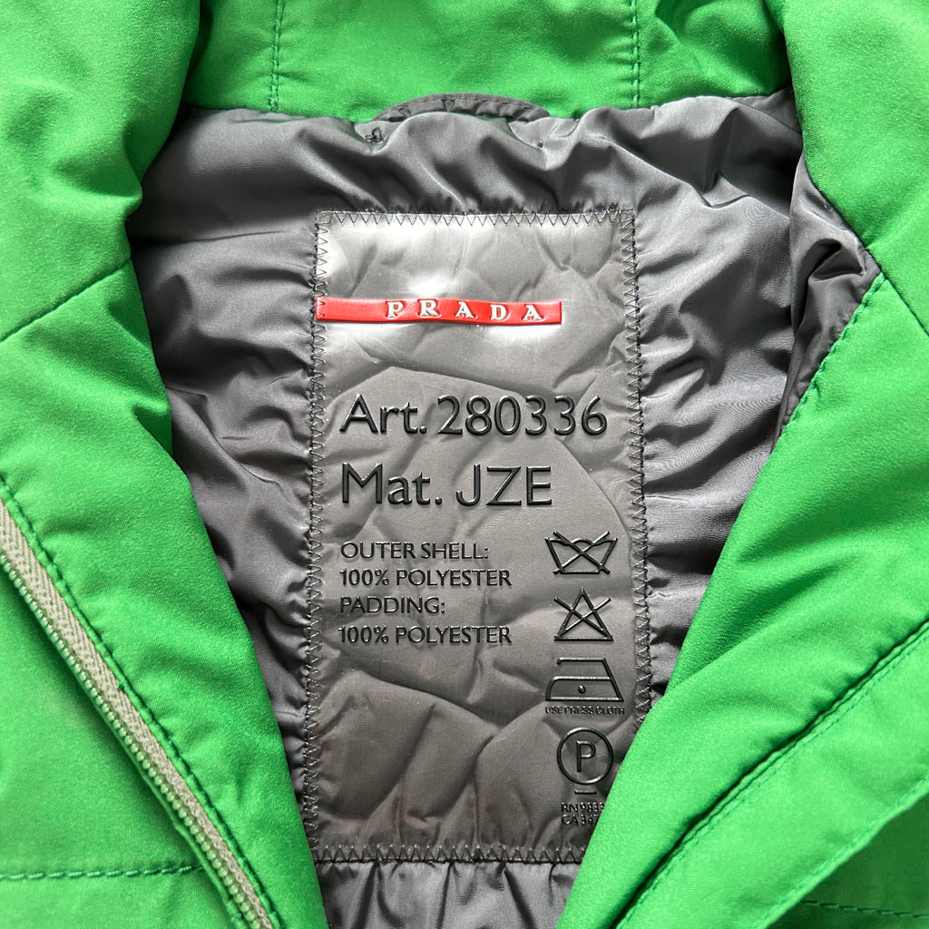 a close-up view of a green jacket with a label on the back, indicating the material and care instructions.