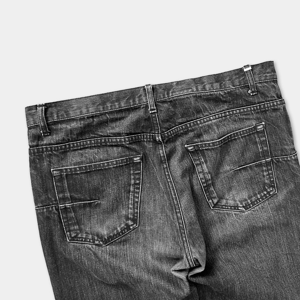 a pair of black and white jeans with visible stitching and pockets.