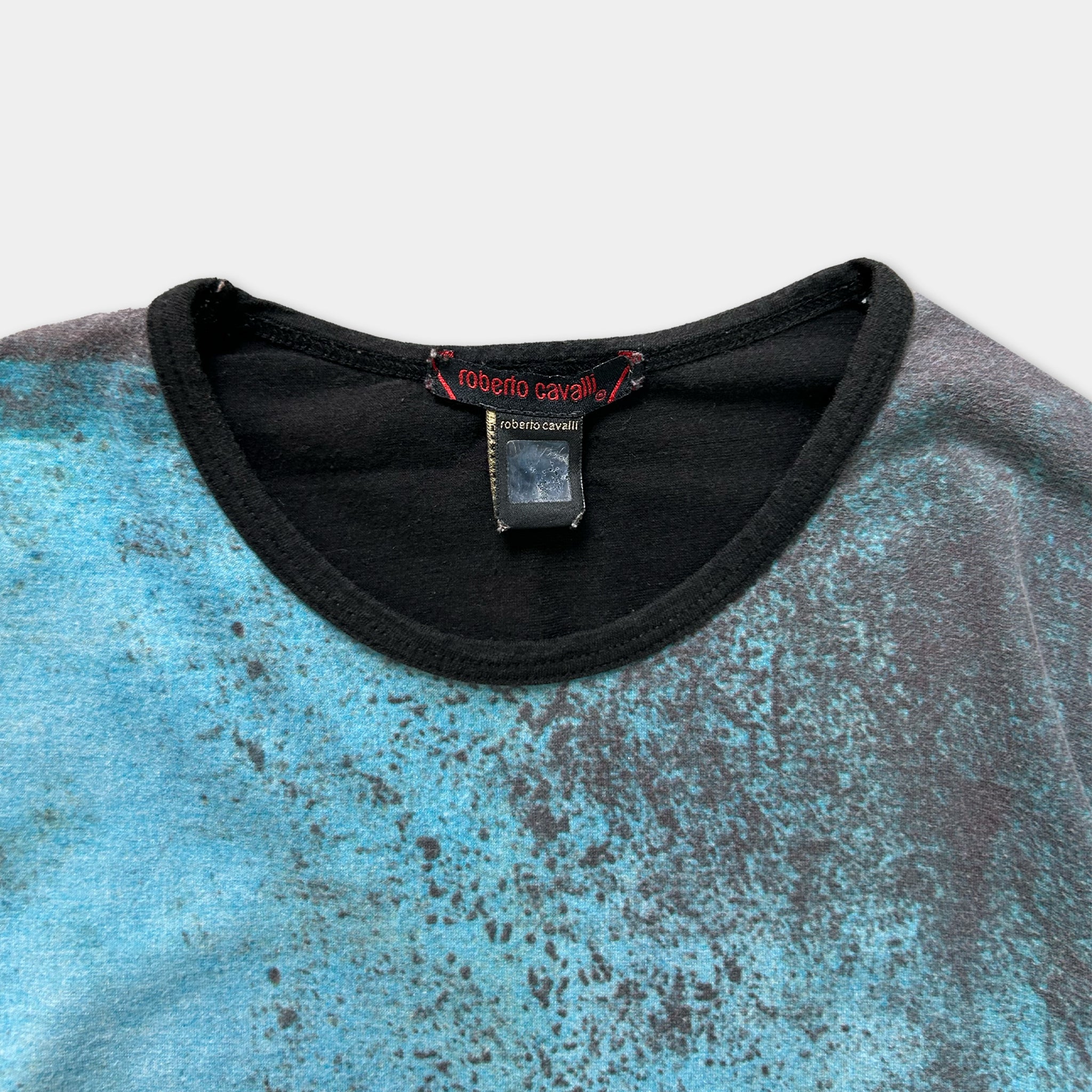 a close-up view of a T-shirt with a blue and black speckled pattern.