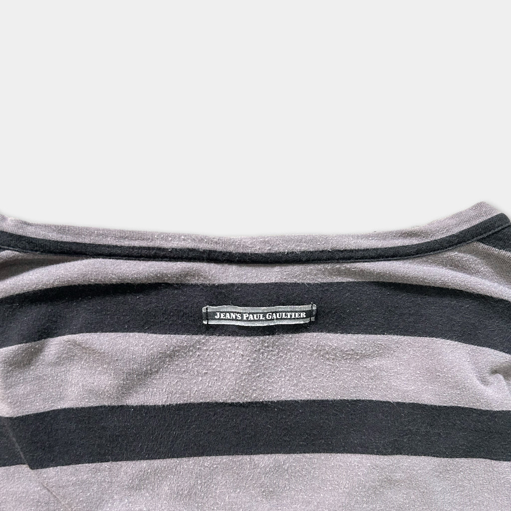 a close-up view of a gray and black striped shirt with a label on the back.