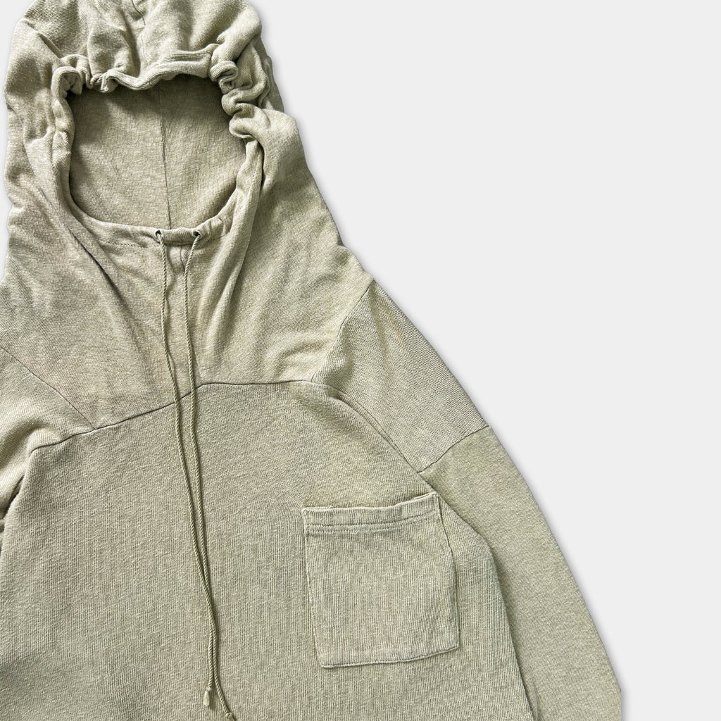 A light-colored hooded sweatshirt with a small pocket on the front.