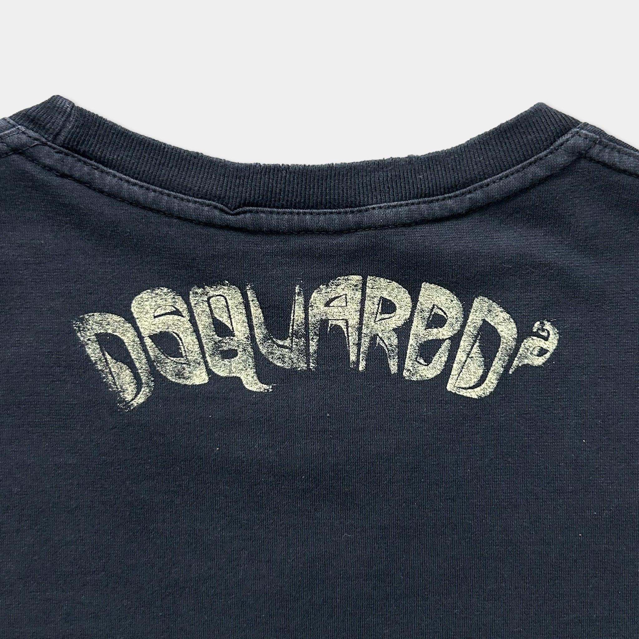 the back of a dark-colored t-shirt with the Dappled logo printed on it.