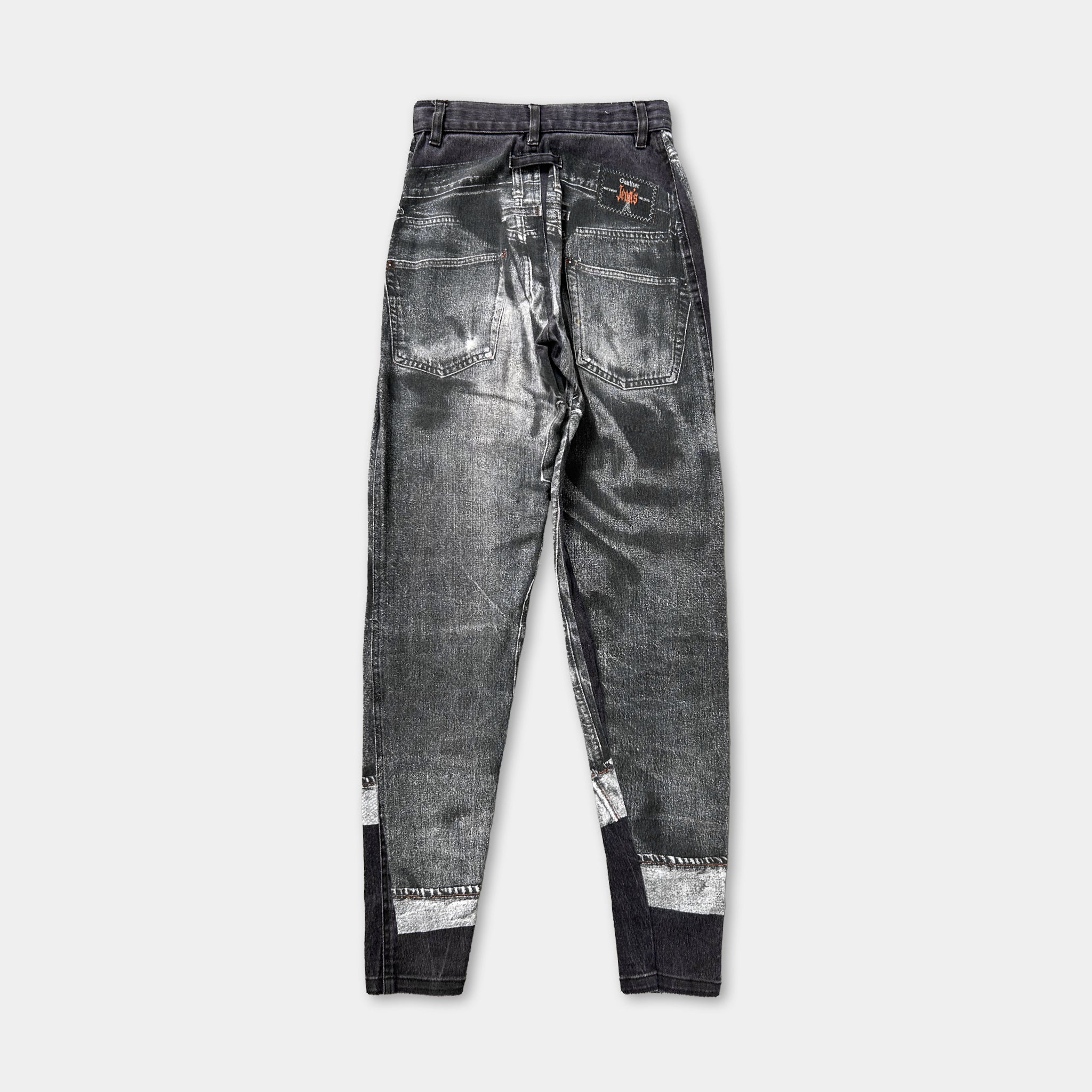 A pair of black and silver metallic jeans with a distinctive pattern.