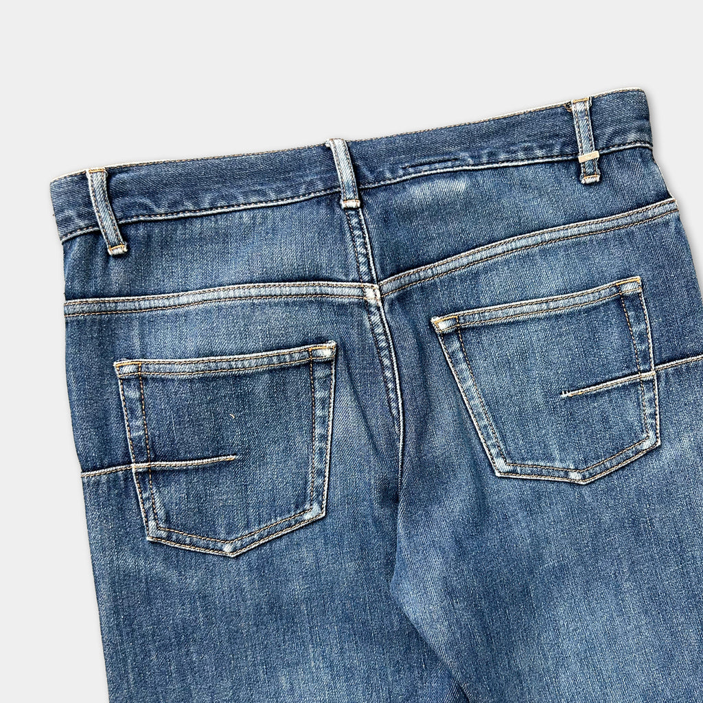 A pair of blue jeans with a zipper and pockets.
