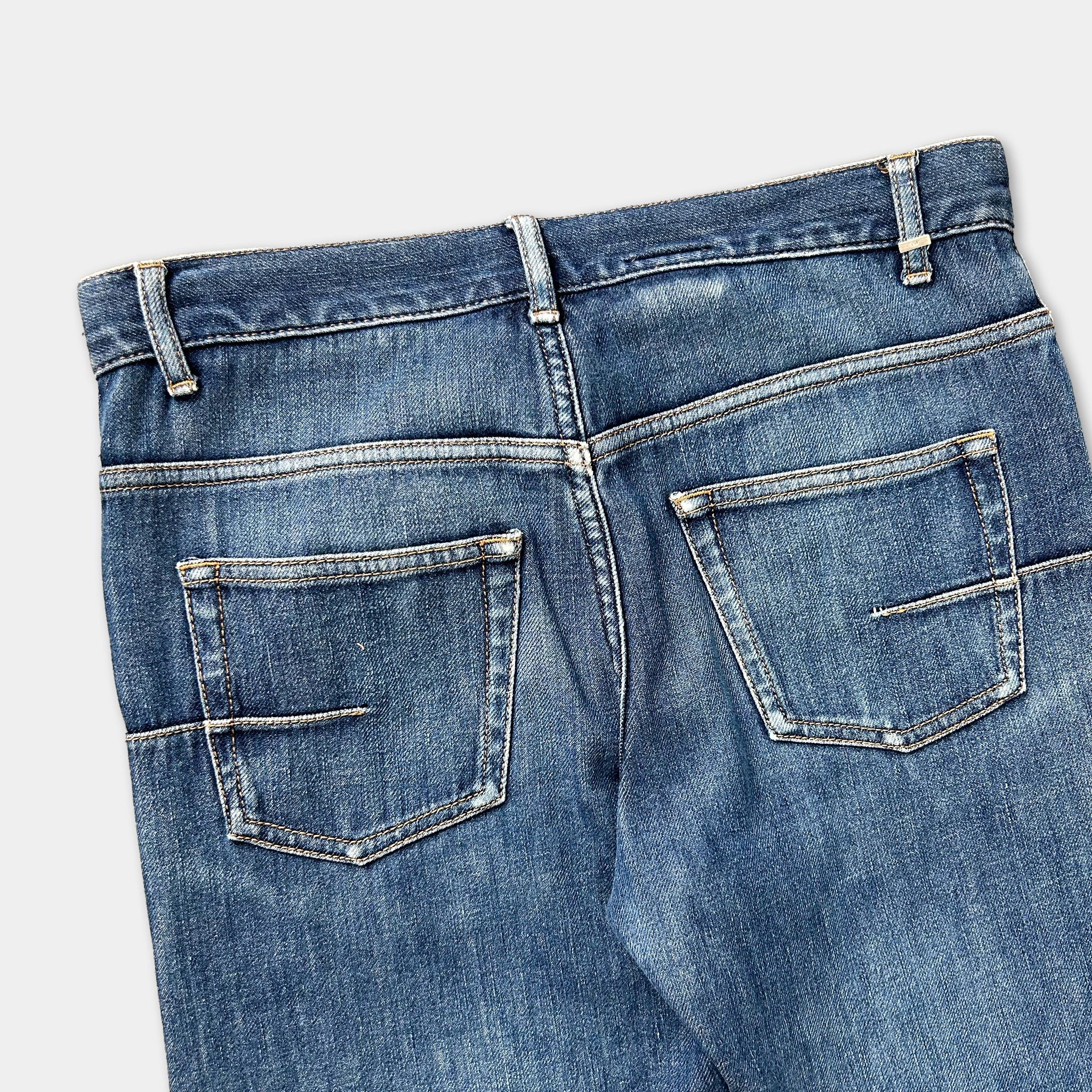 A pair of blue jeans with a zipper and pockets.
