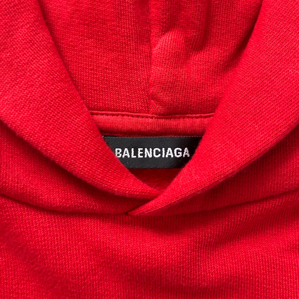 A close-up view of a red hoodie with a label that reads "BALENCIA".