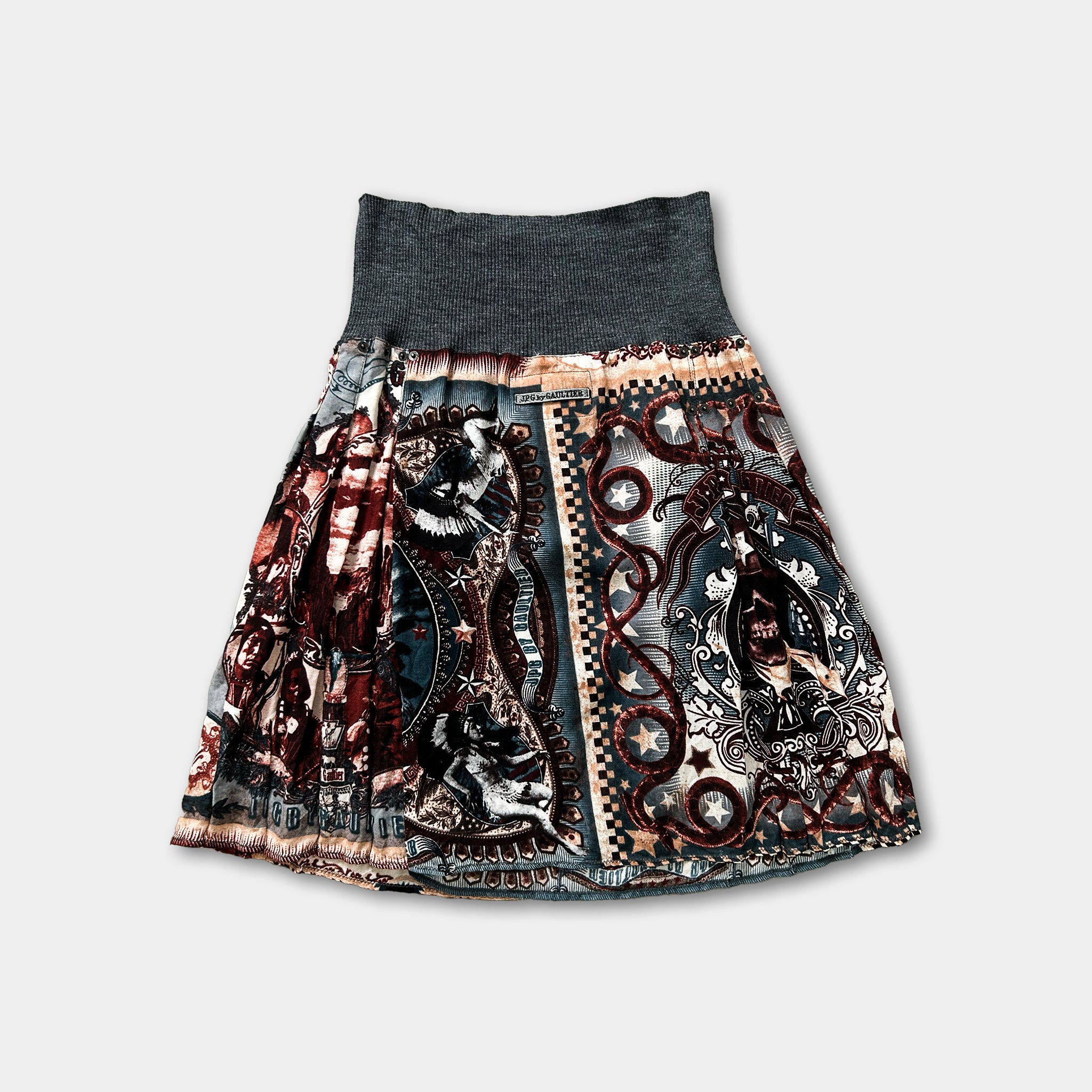 A colorful, patterned skirt with a high waist and a dark gray top.
