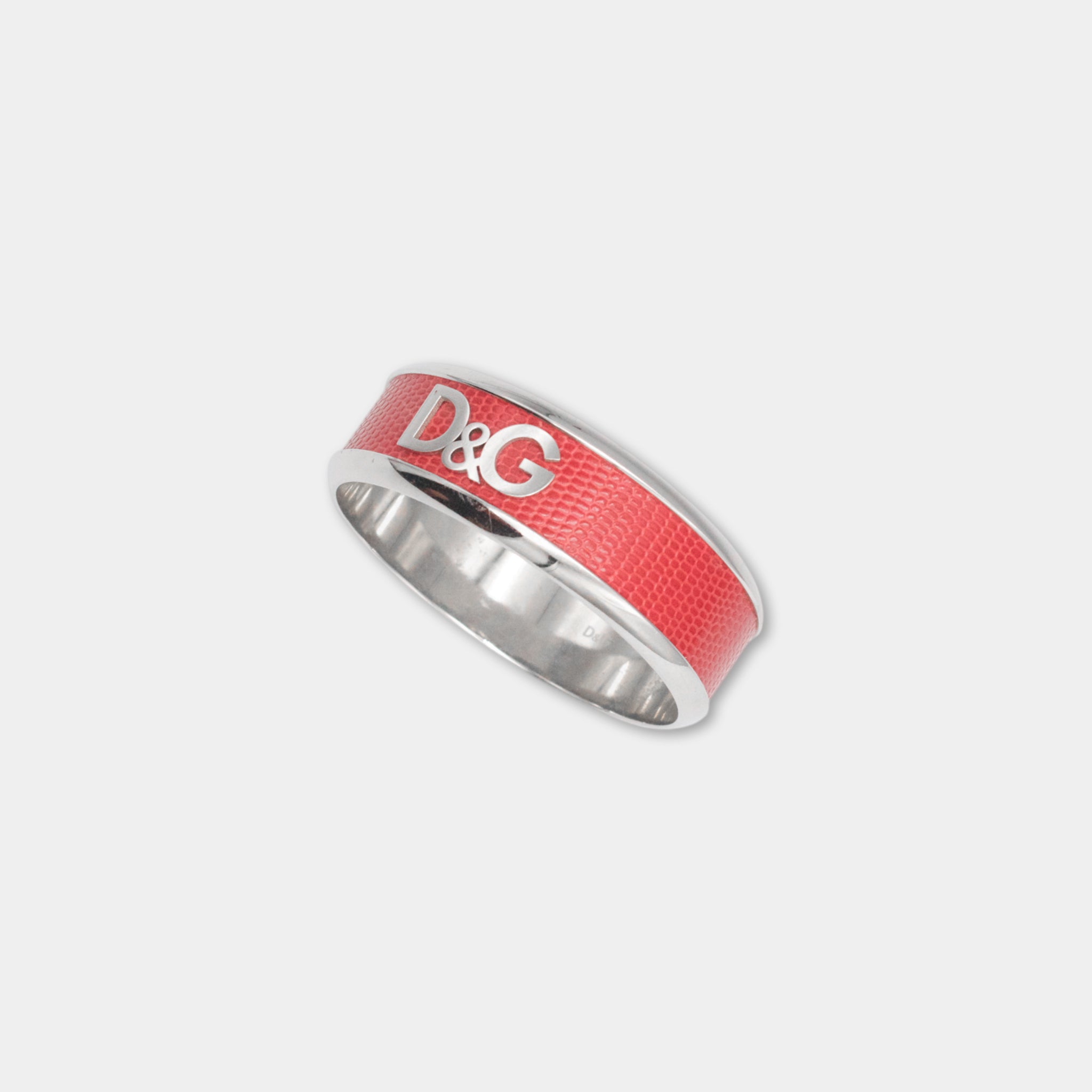A red ring with the letters 'D&G' on it, which is a part of a silver band.